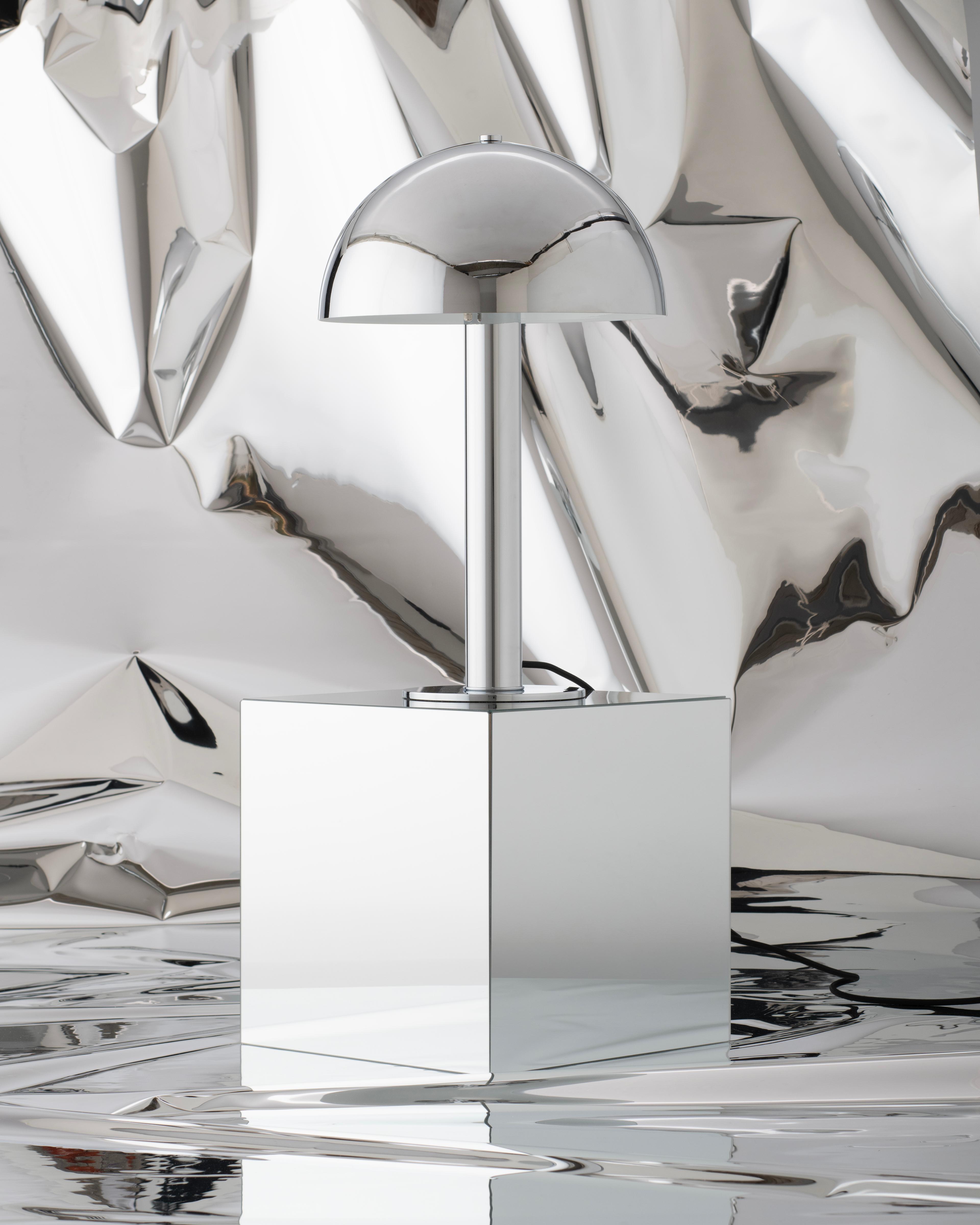Chrome lamp on a pedestal.