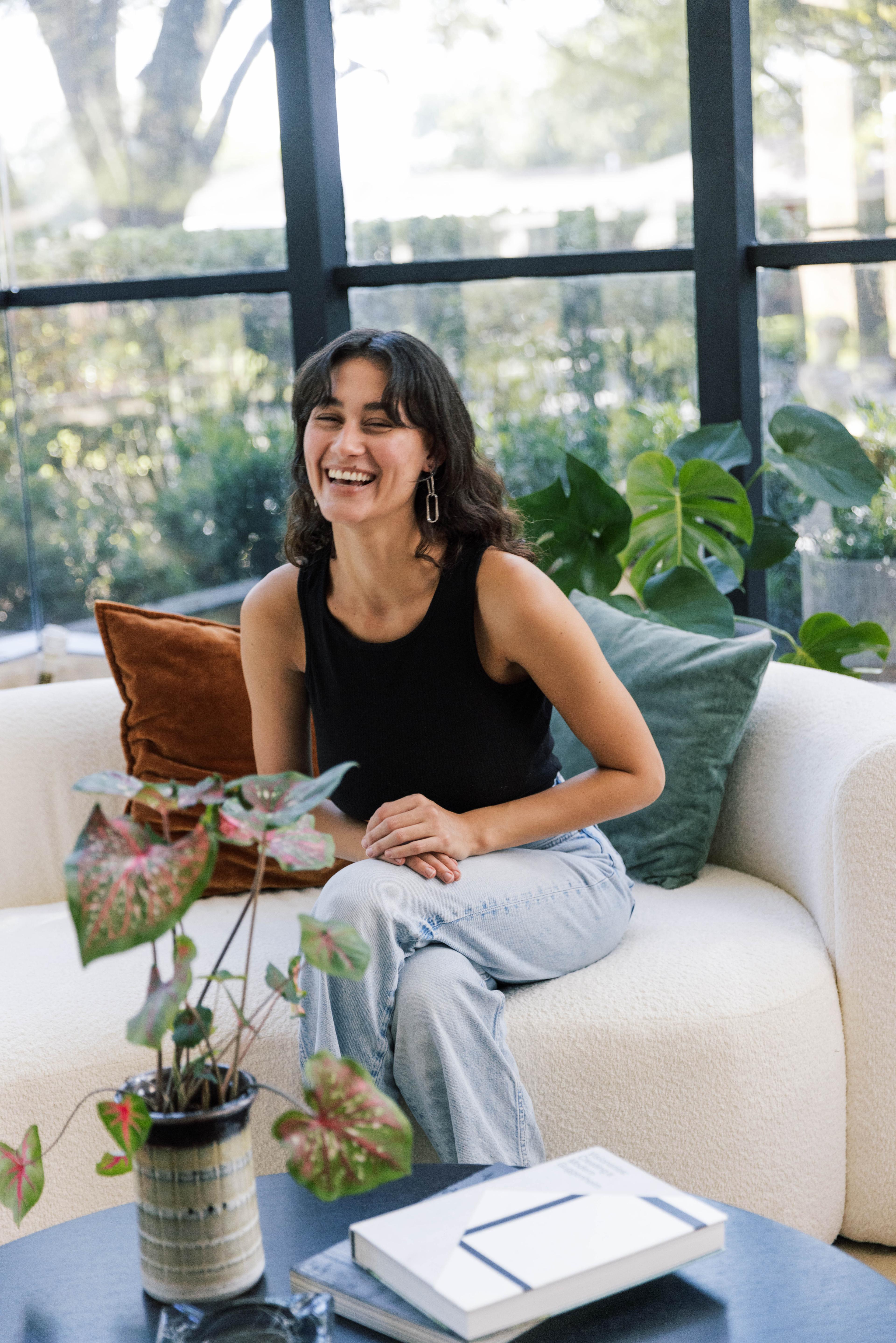 Woman sitting on couch.