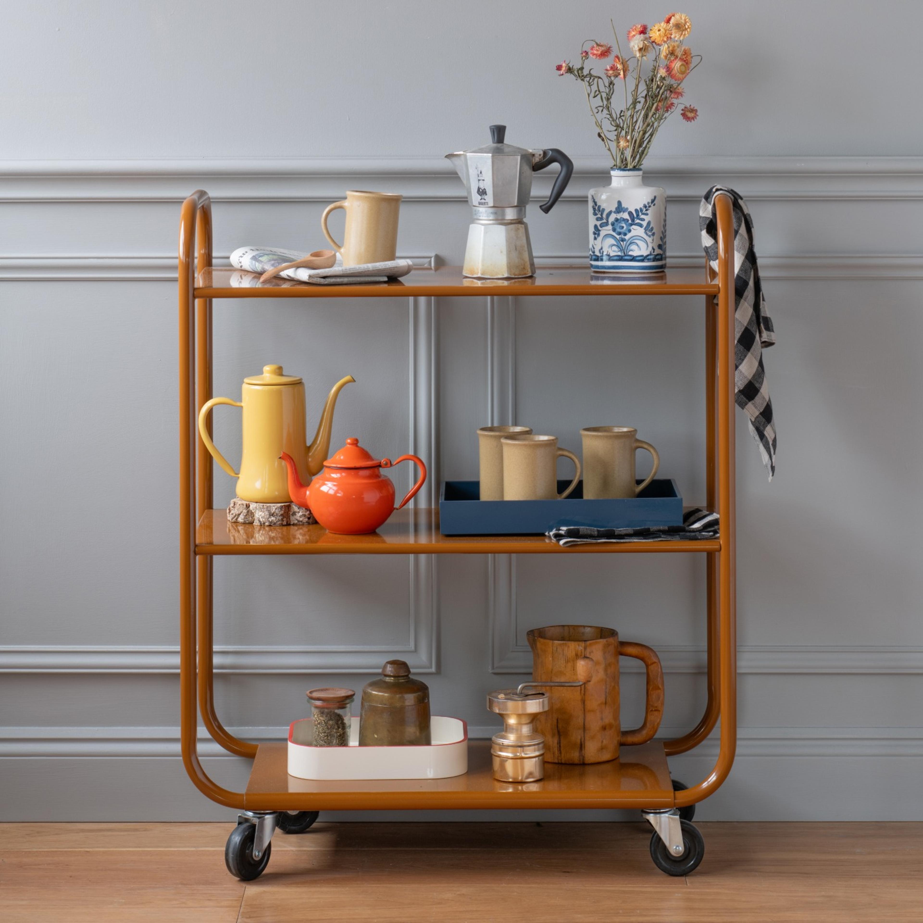 Bar cart decorated with flowers, coffee pots and mugs