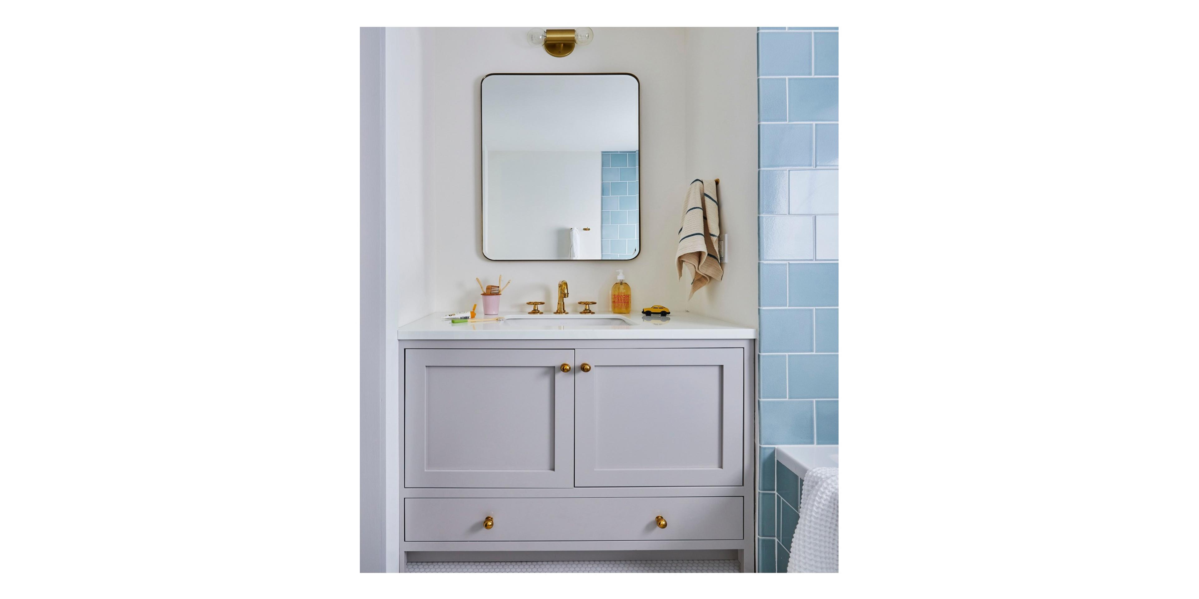 Serene bathroom with blue tile and white walls. 