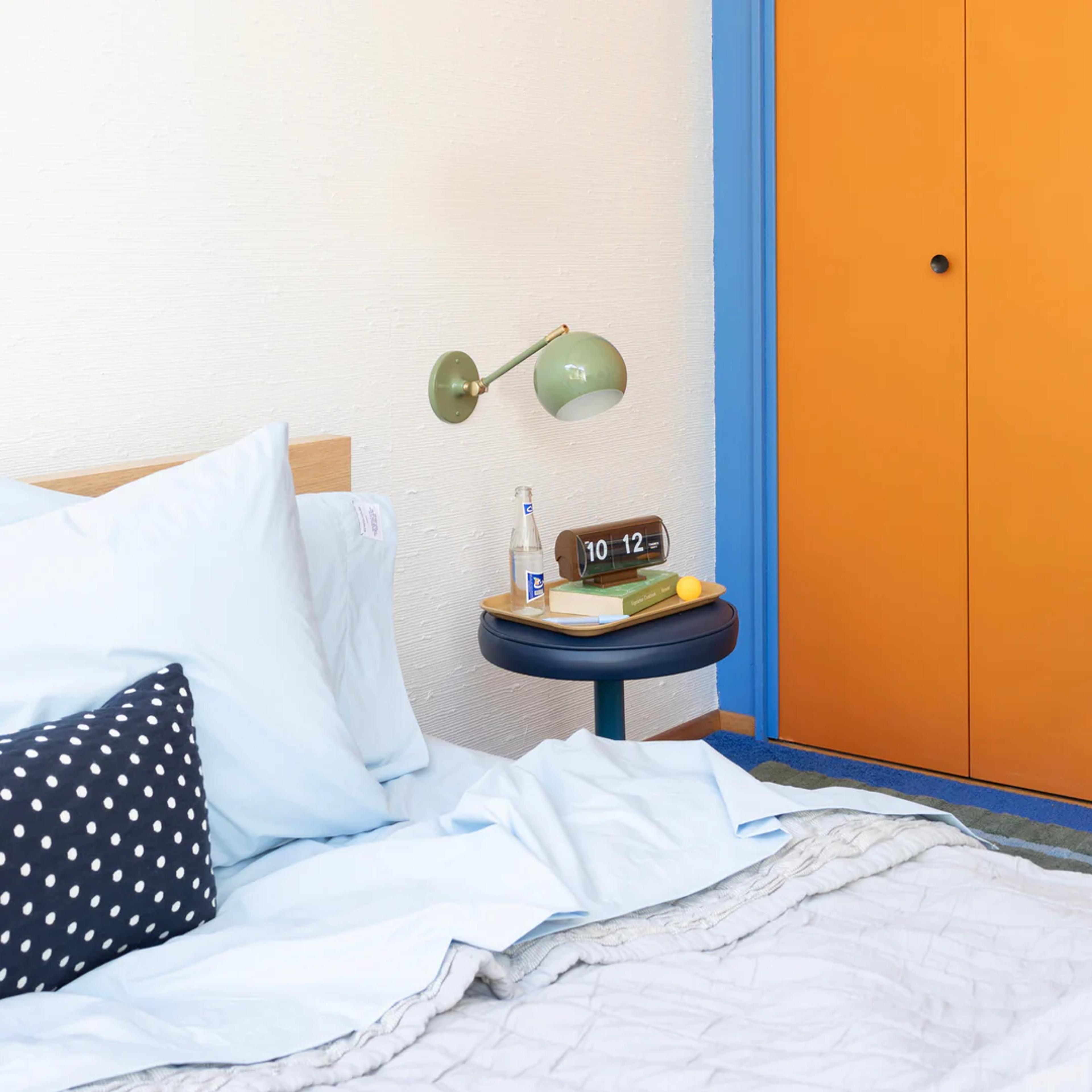 Lamp above bedside table.