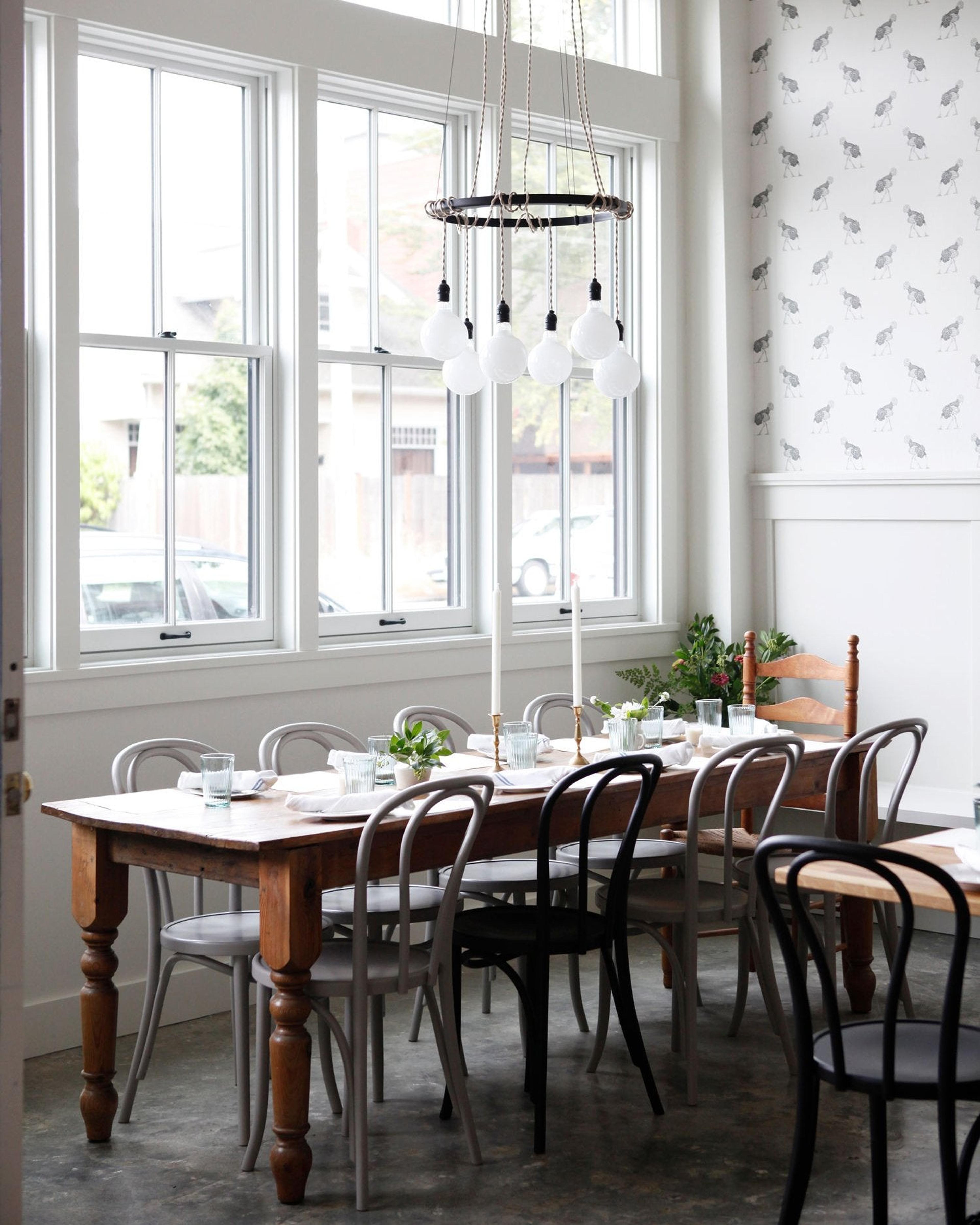 dining room with table and chairs and large windows