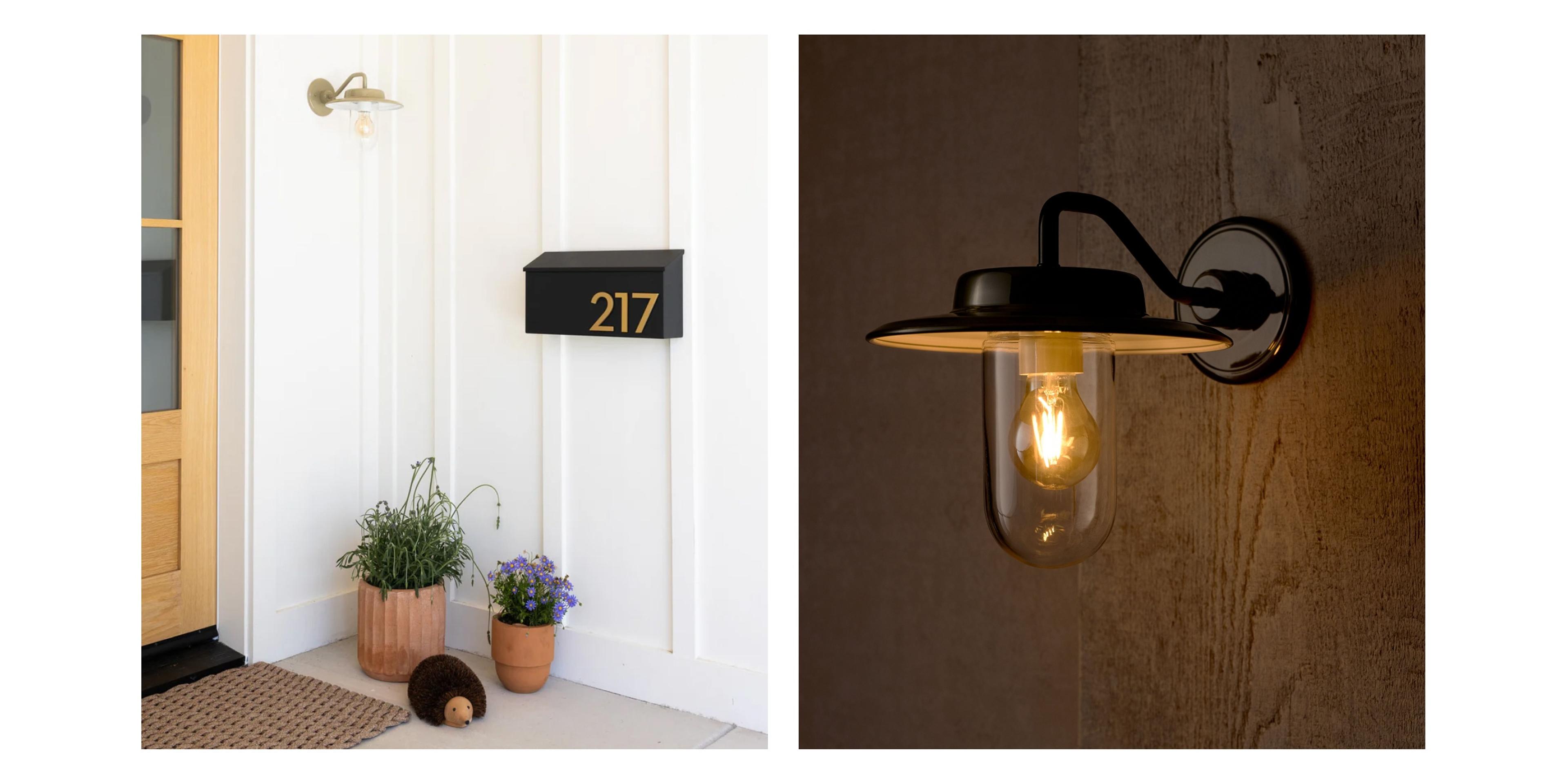 wooden front door with plants, mailbox and sage green factory sconce