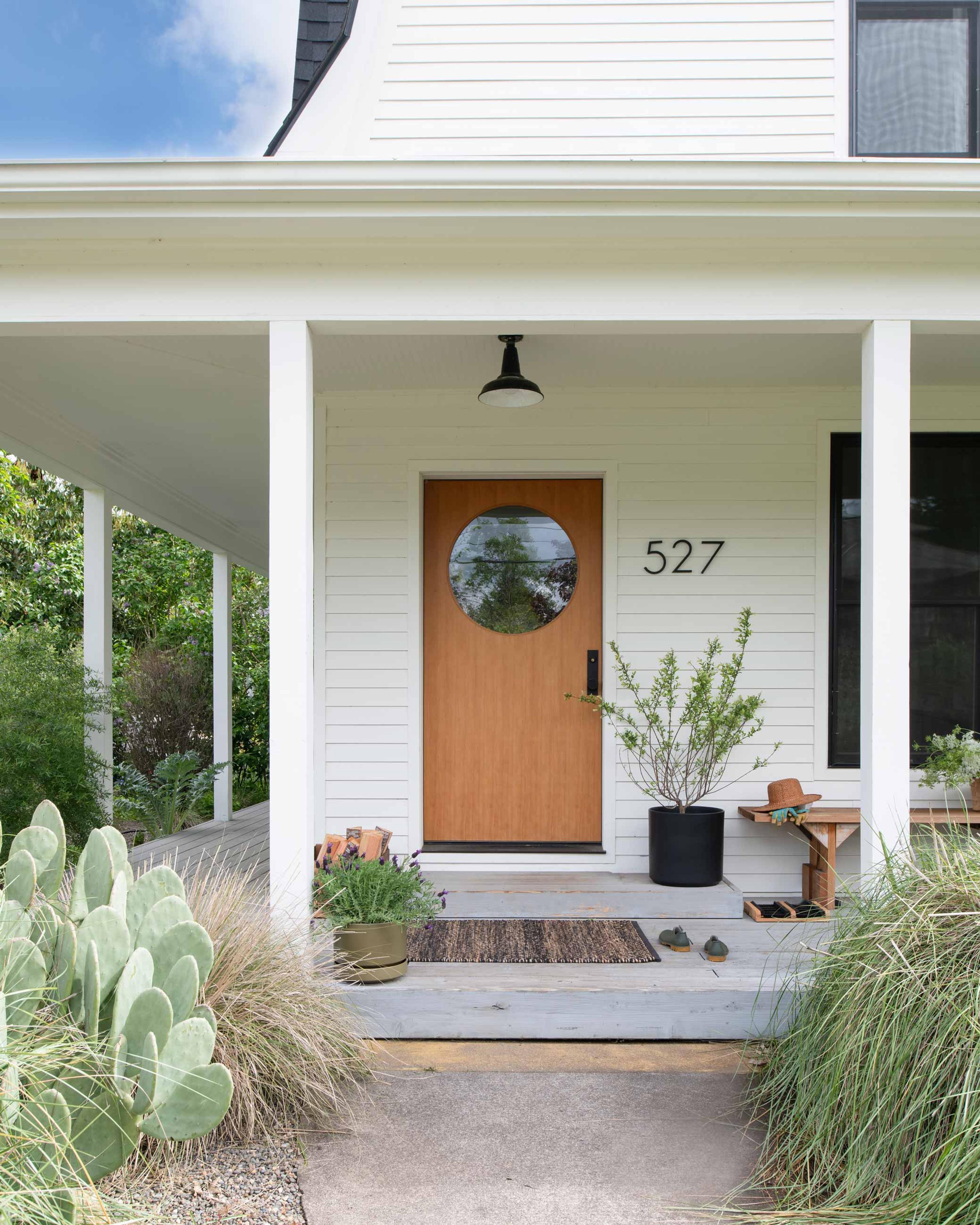 Front exterior of home showcasing pendant light above entryway on porch