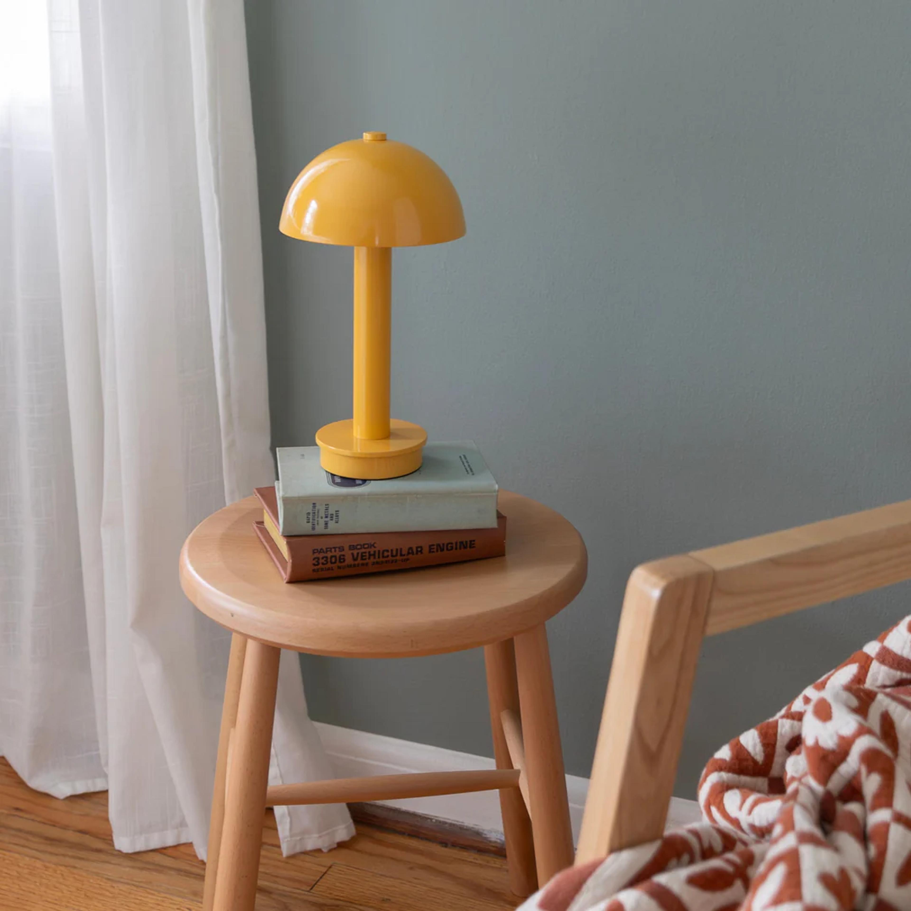 Portable lamp on a stool.