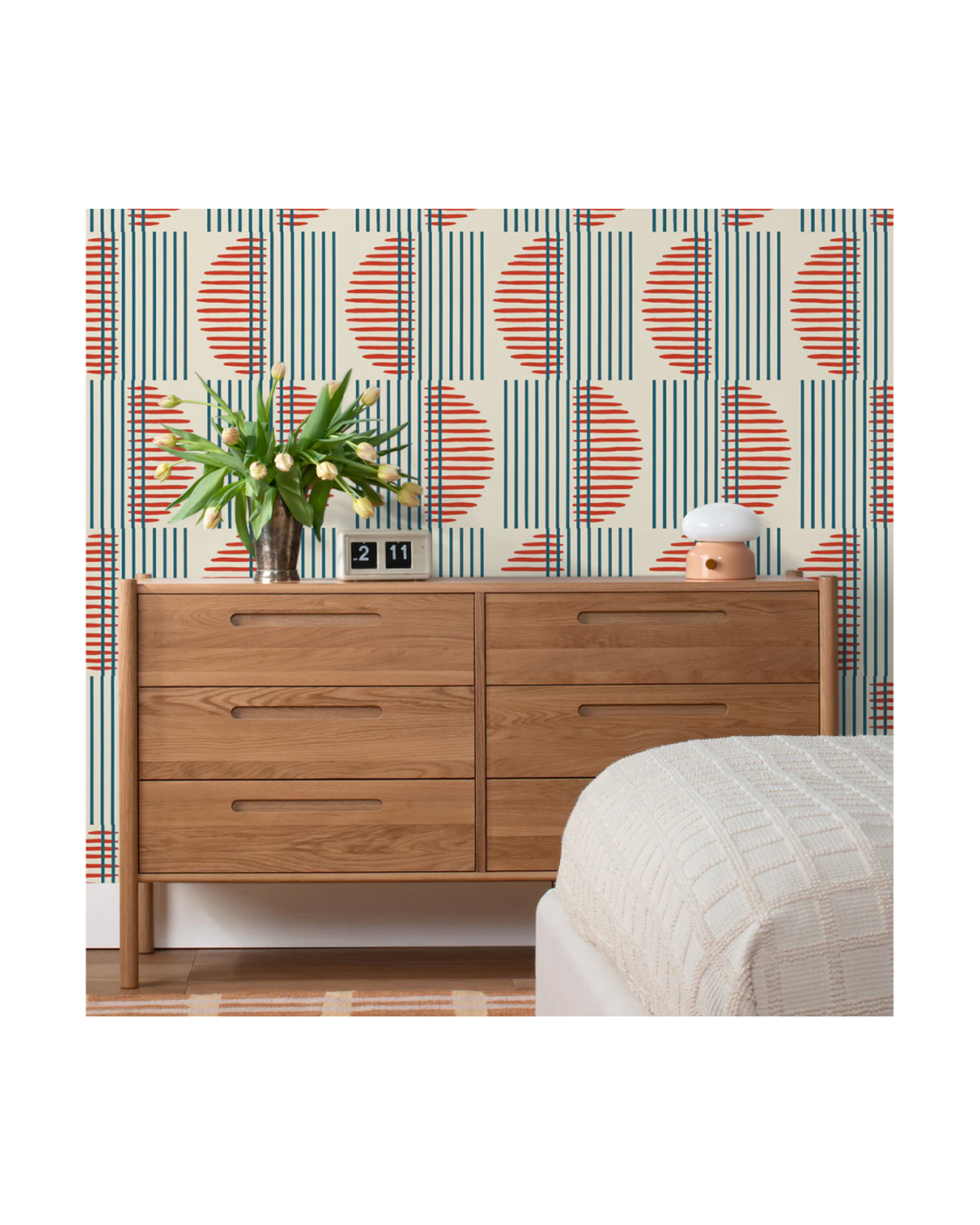 Funky wallpaper with oak dresser.