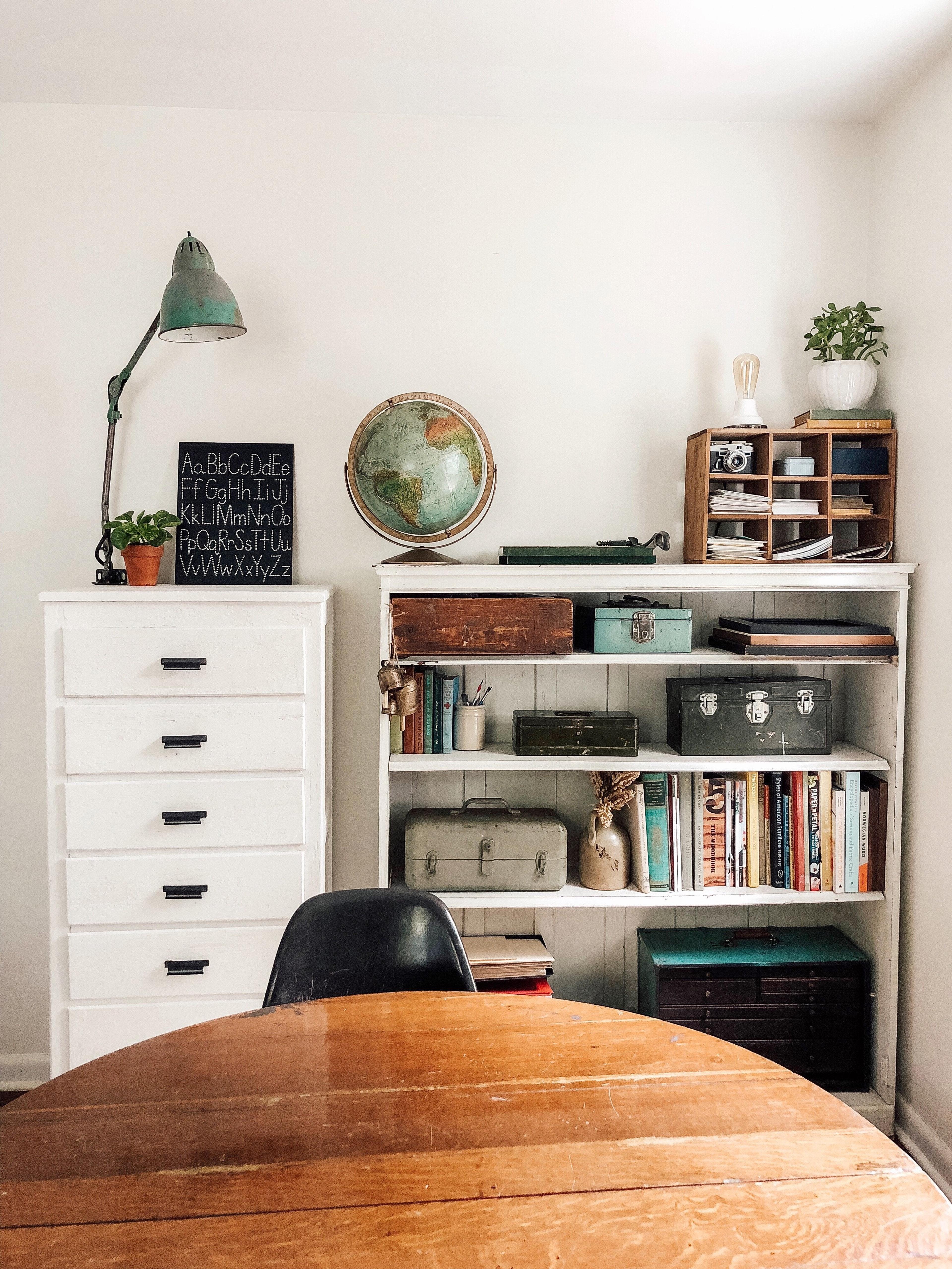 room with a bookcase and a shelf with books on it