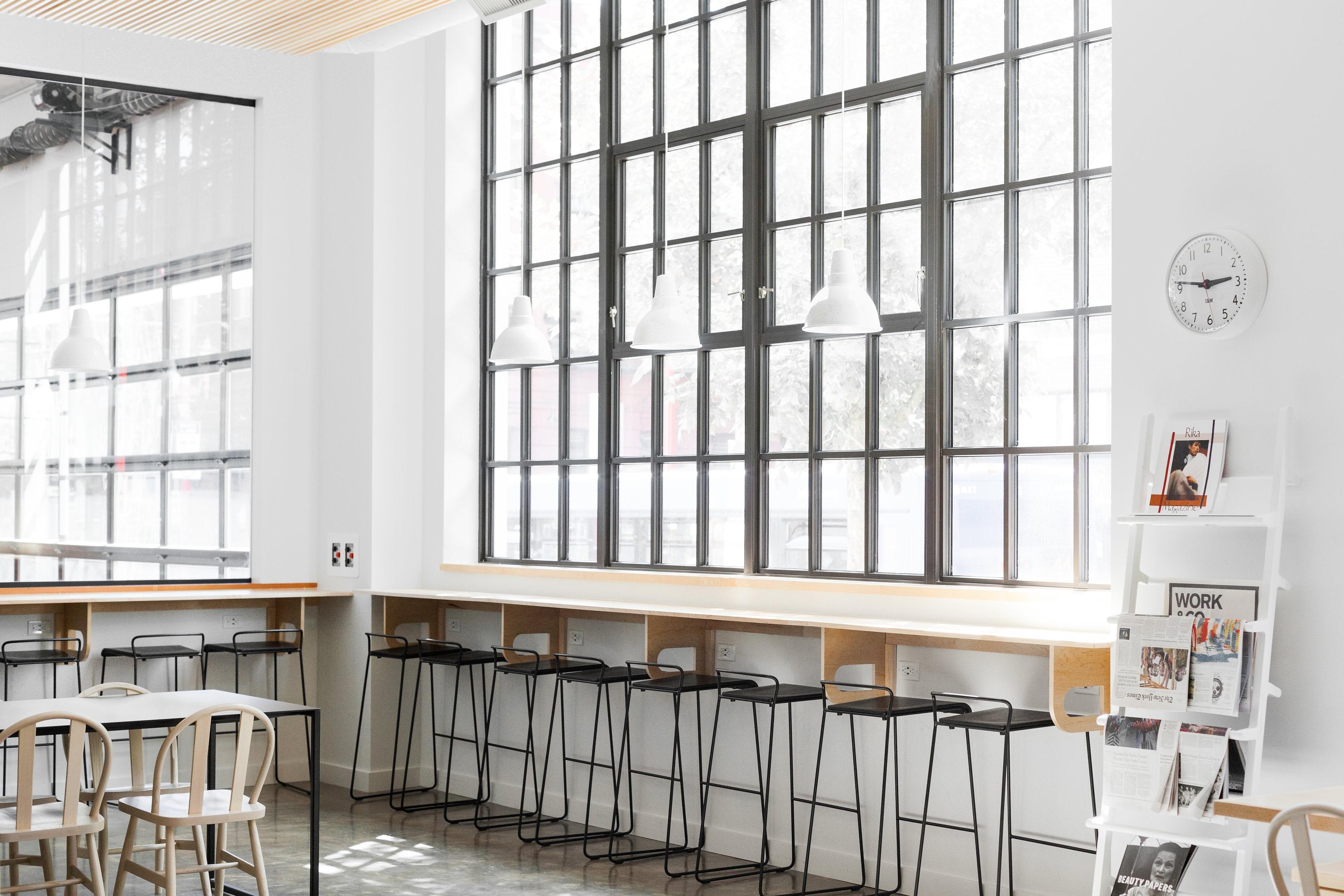 room with a large window and bar and bar stools