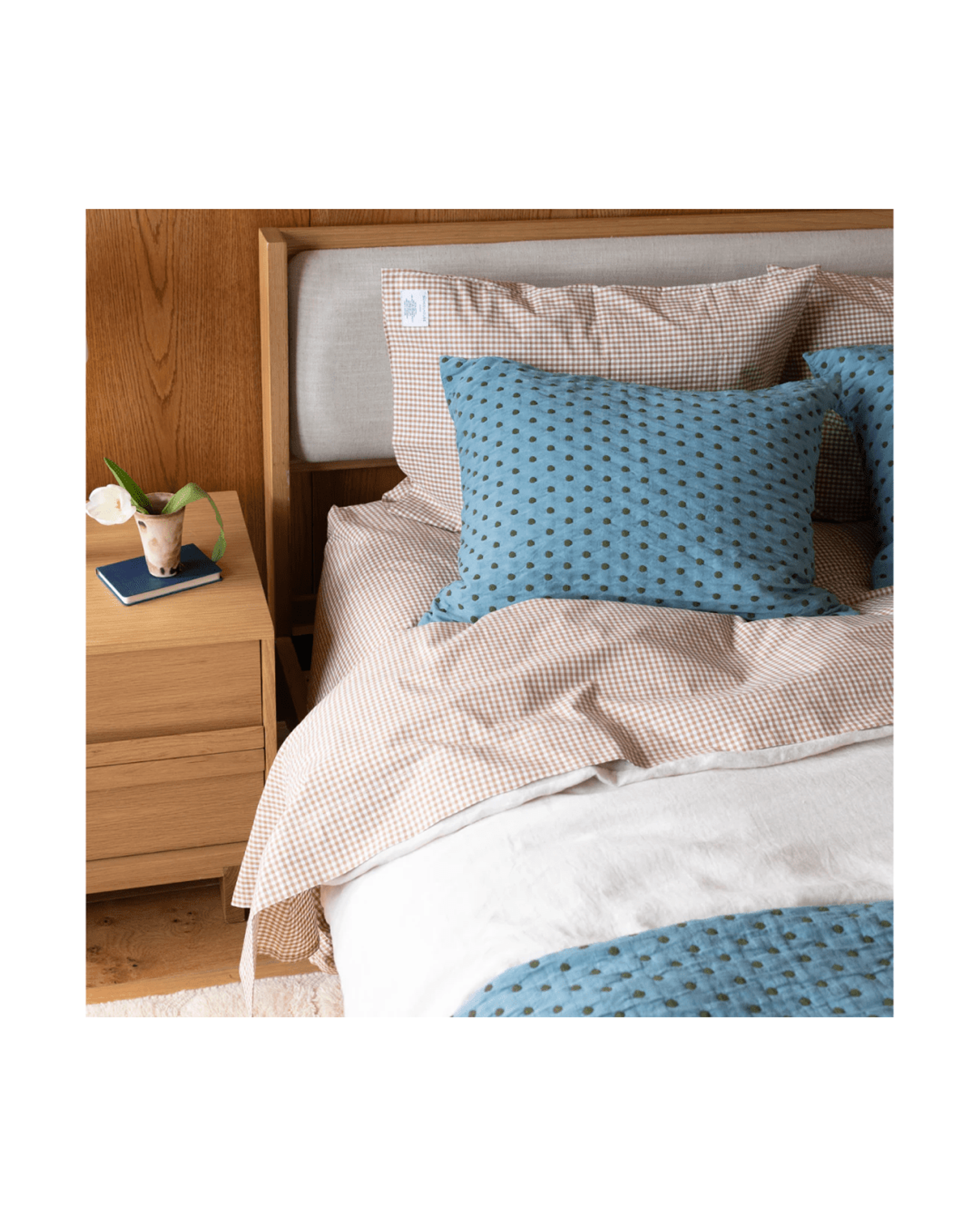 Cozy bed with blue and red bedding. 