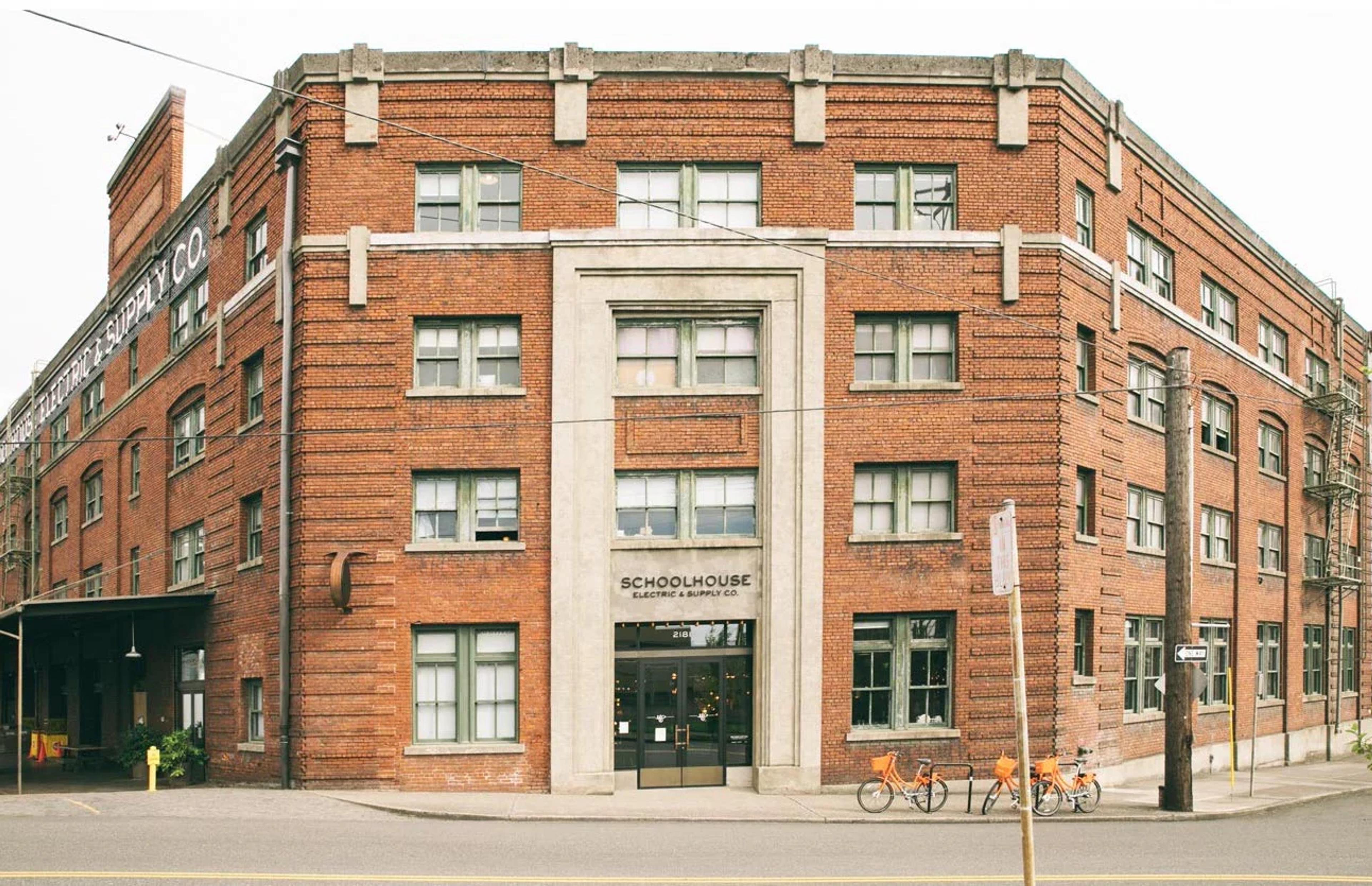 Exterior view of the front of the four-story Schoolhouse Electric brick building.