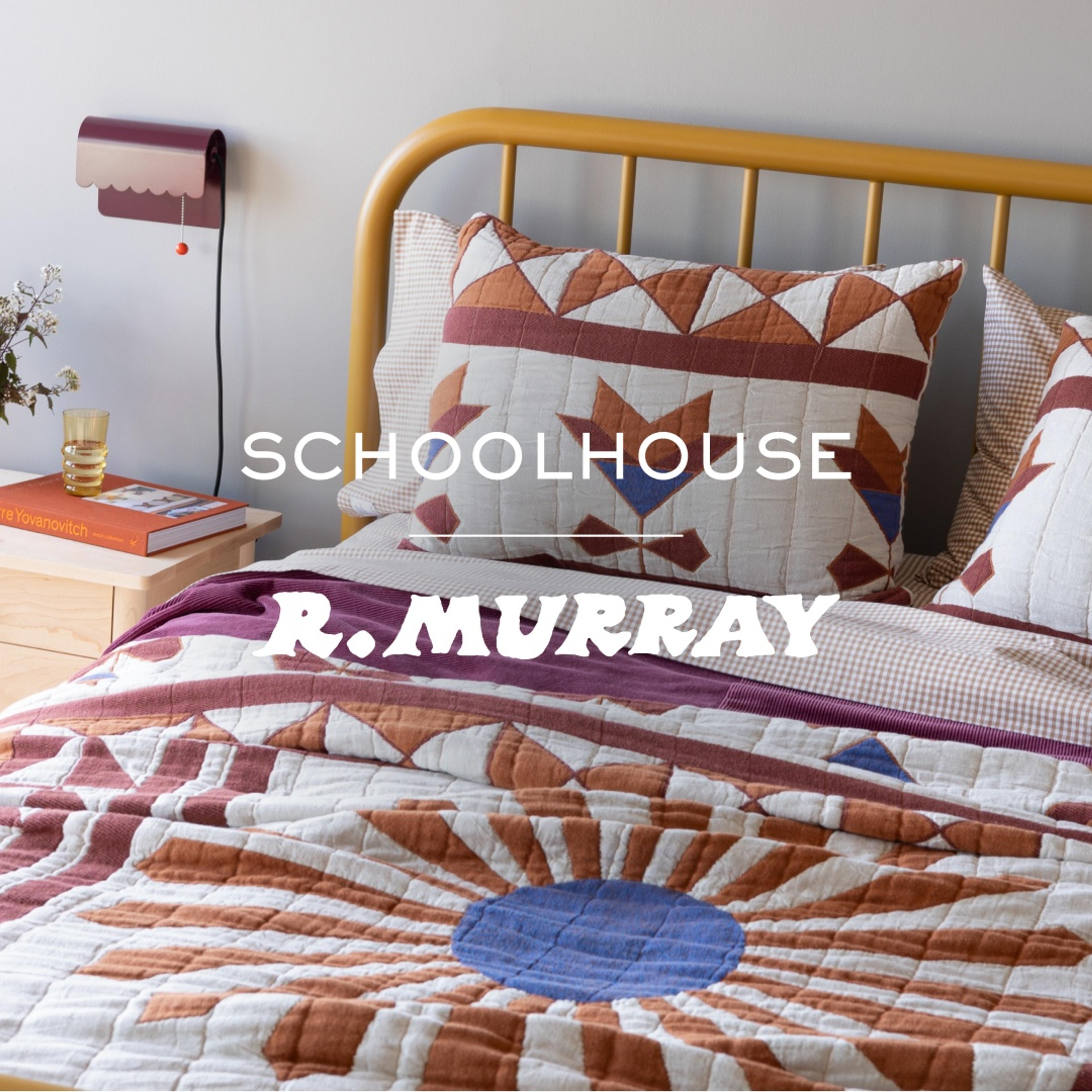 Bed with a colorful quilt and shams, plug in scalloped sconce on the wall