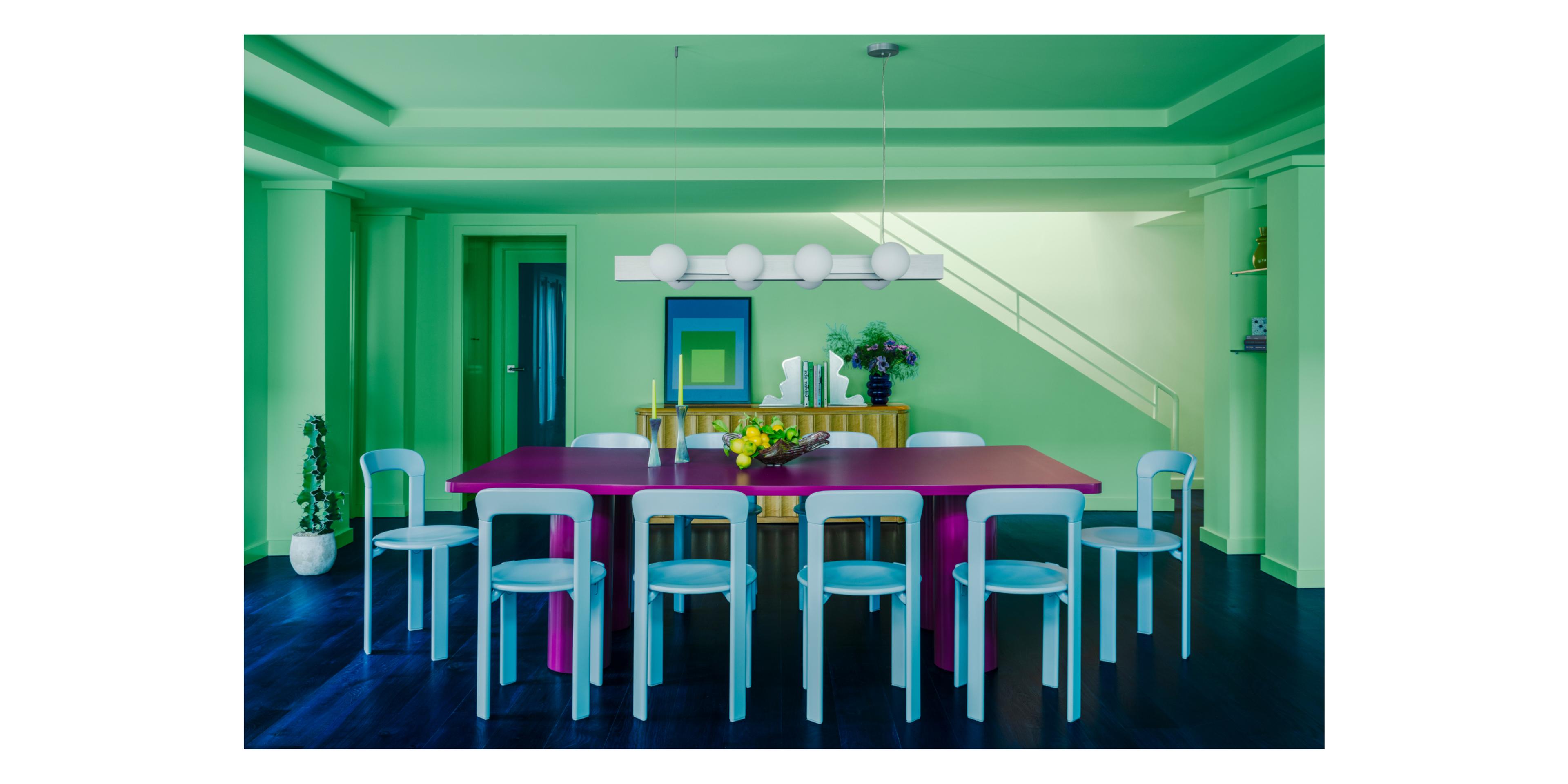 green dining room with magenta table and sky blue chairs 