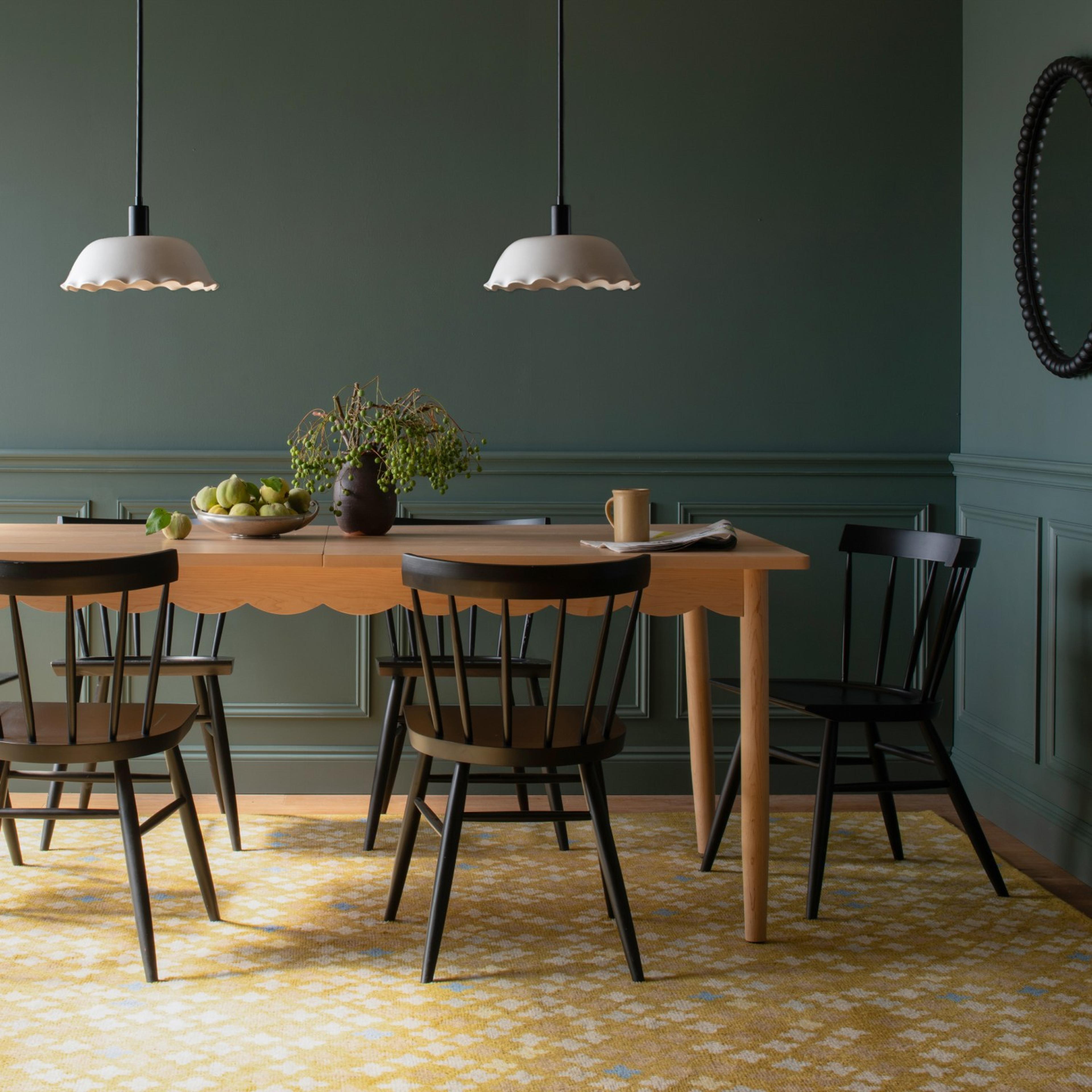 Table and chairs on a yellow rug