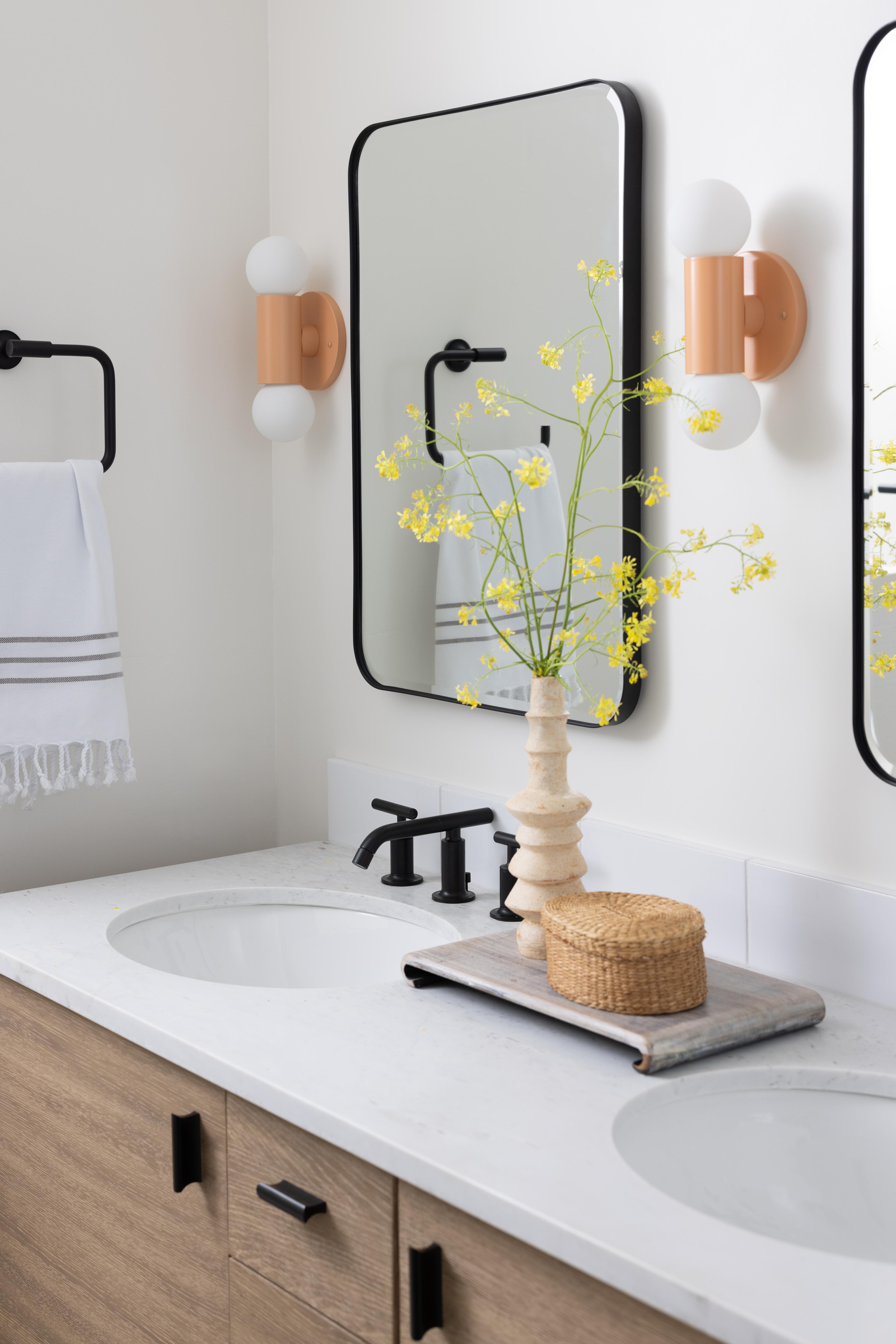 Pink sconces in modern bathroom.