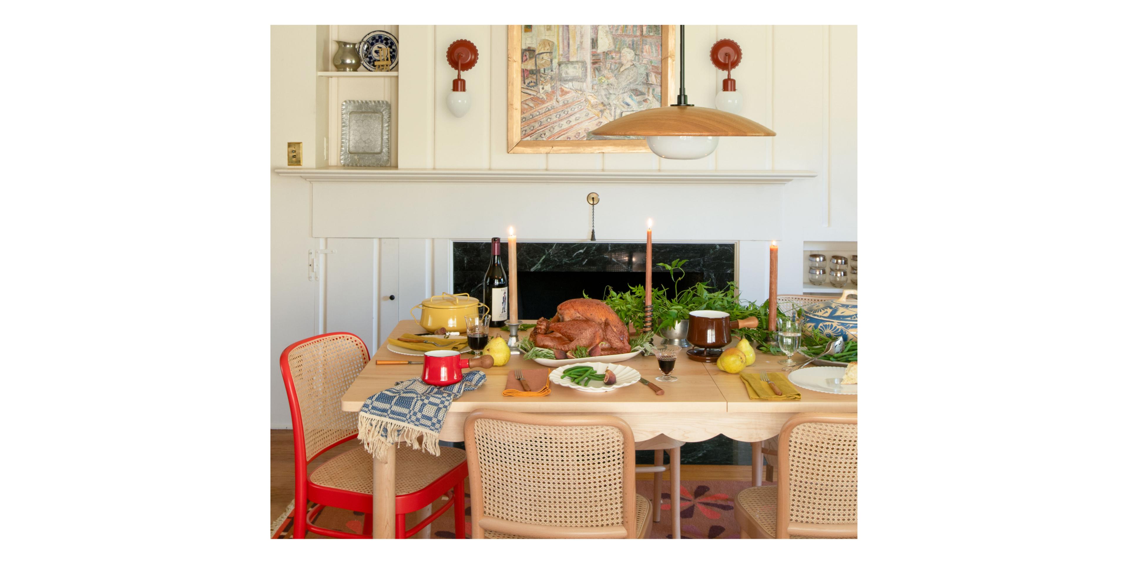 beechwood table with scallops set for the holidays with lit candles