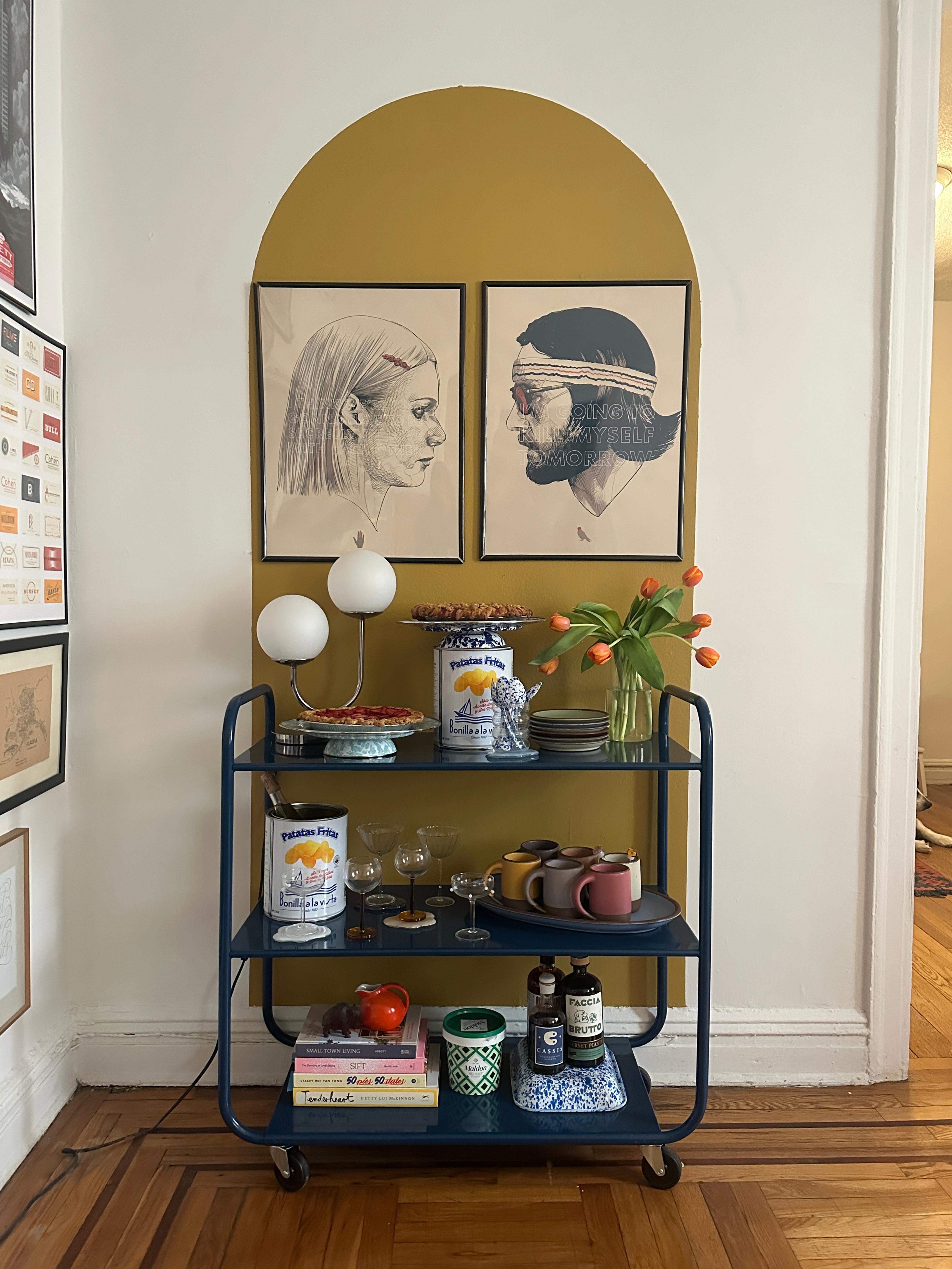 Bar cart in dining room with fresh baked pie and alcohol bottles 