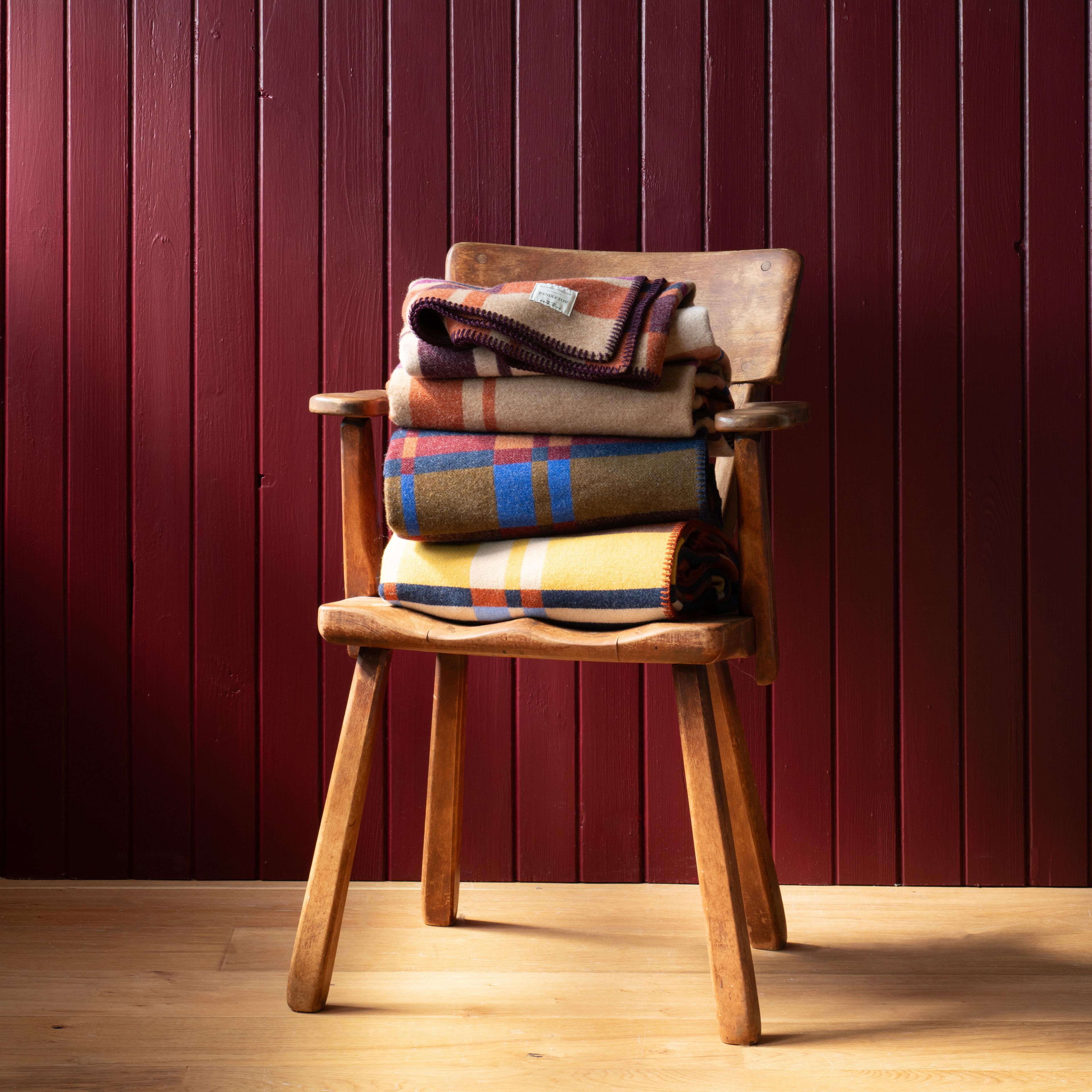 Blankets stacked on chair.