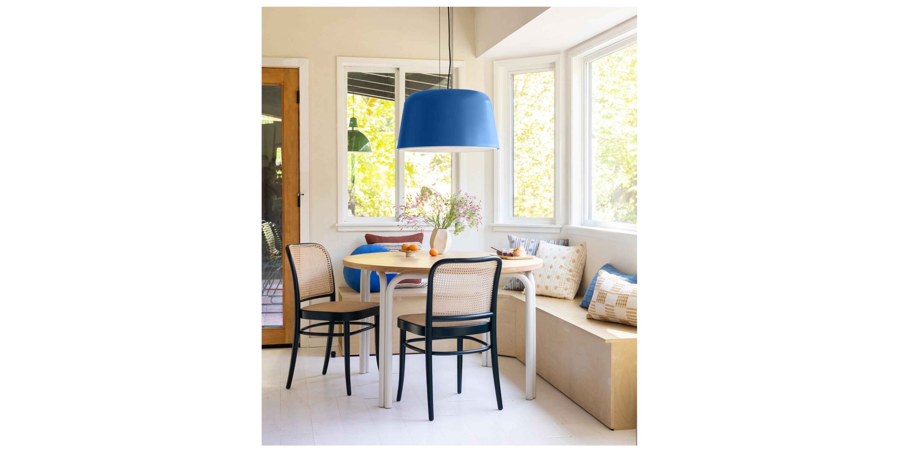 dining room nook with round table and blue chandelier 