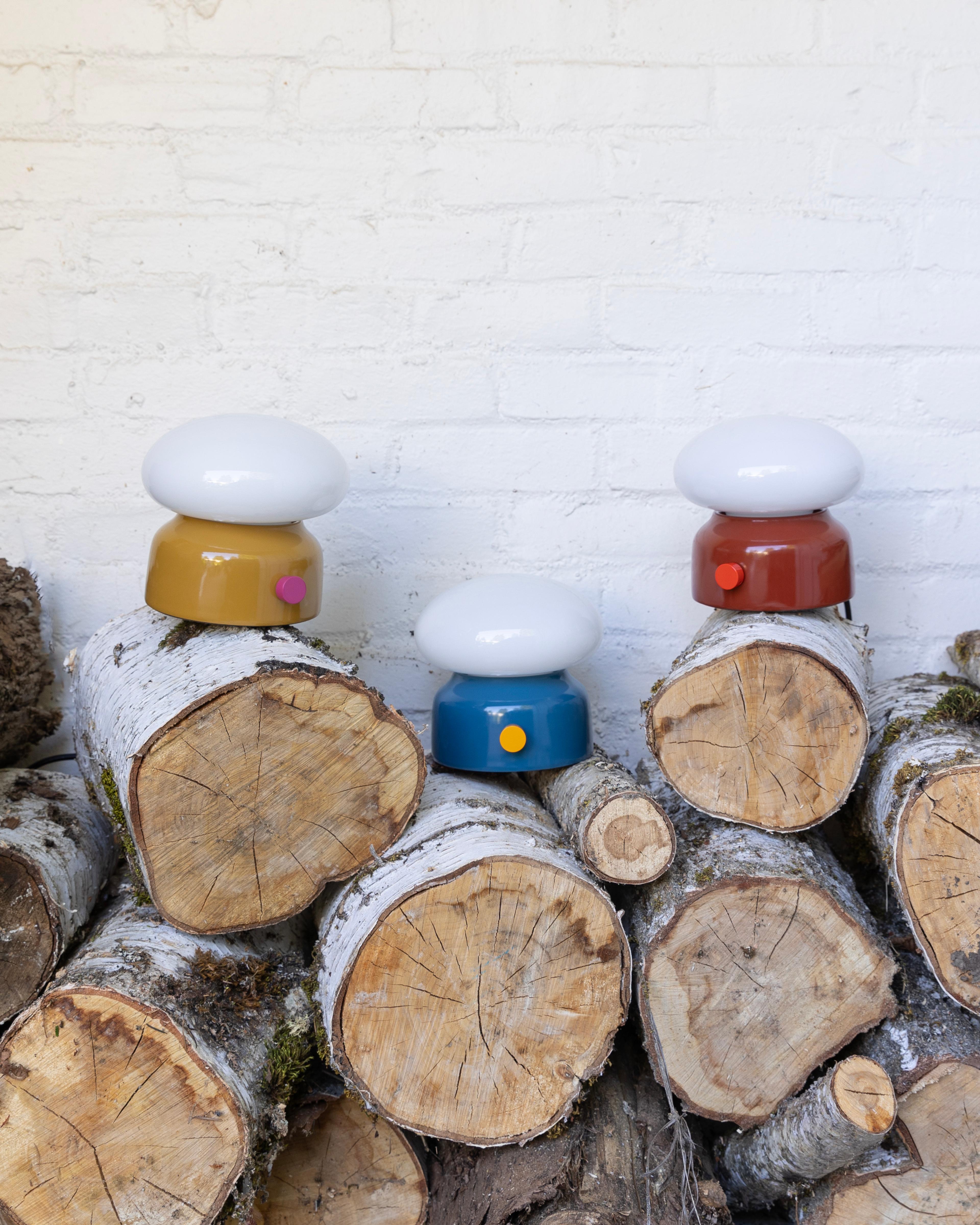 Three lamps sitting on firewood.