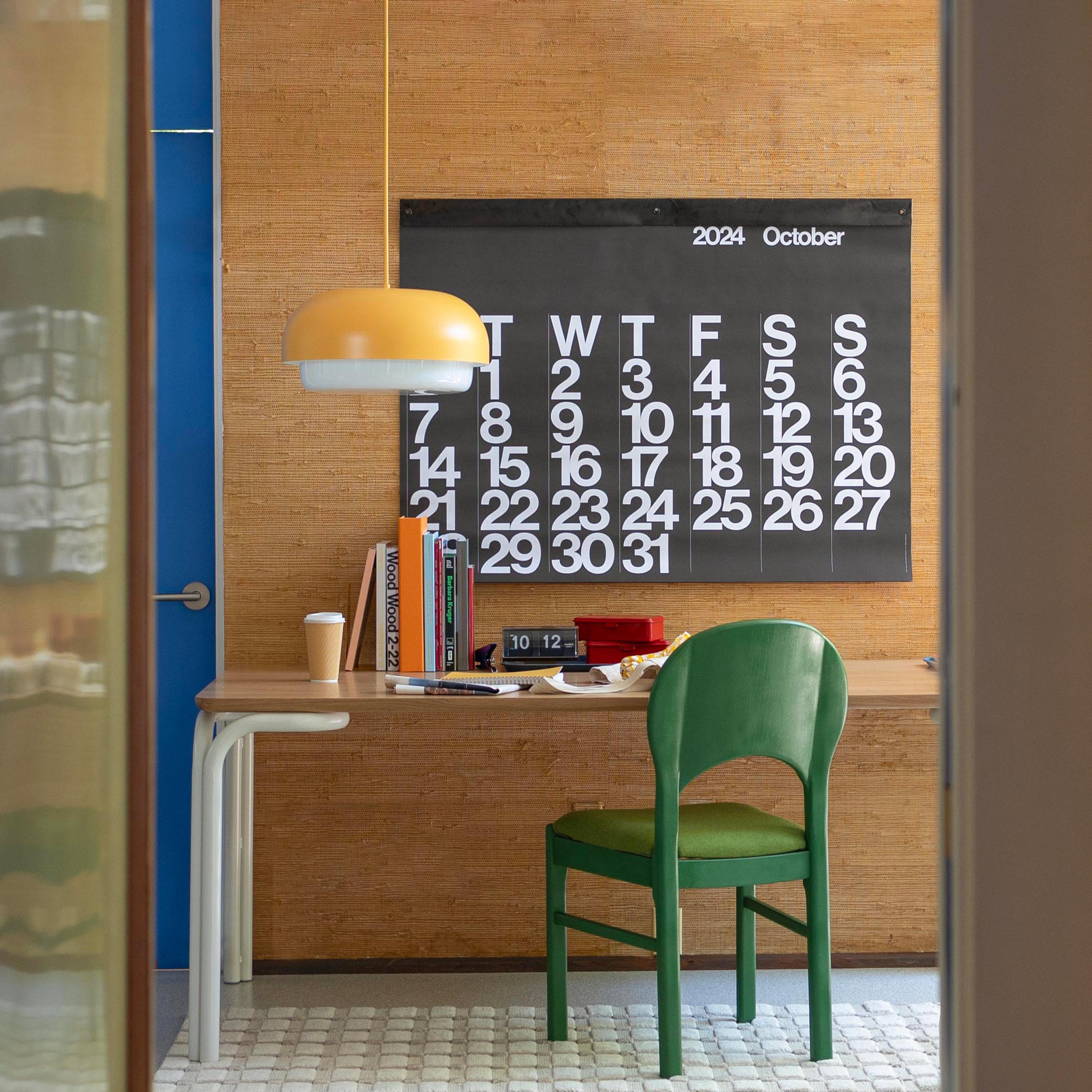 modern office with big picture calendar and yellow pendant