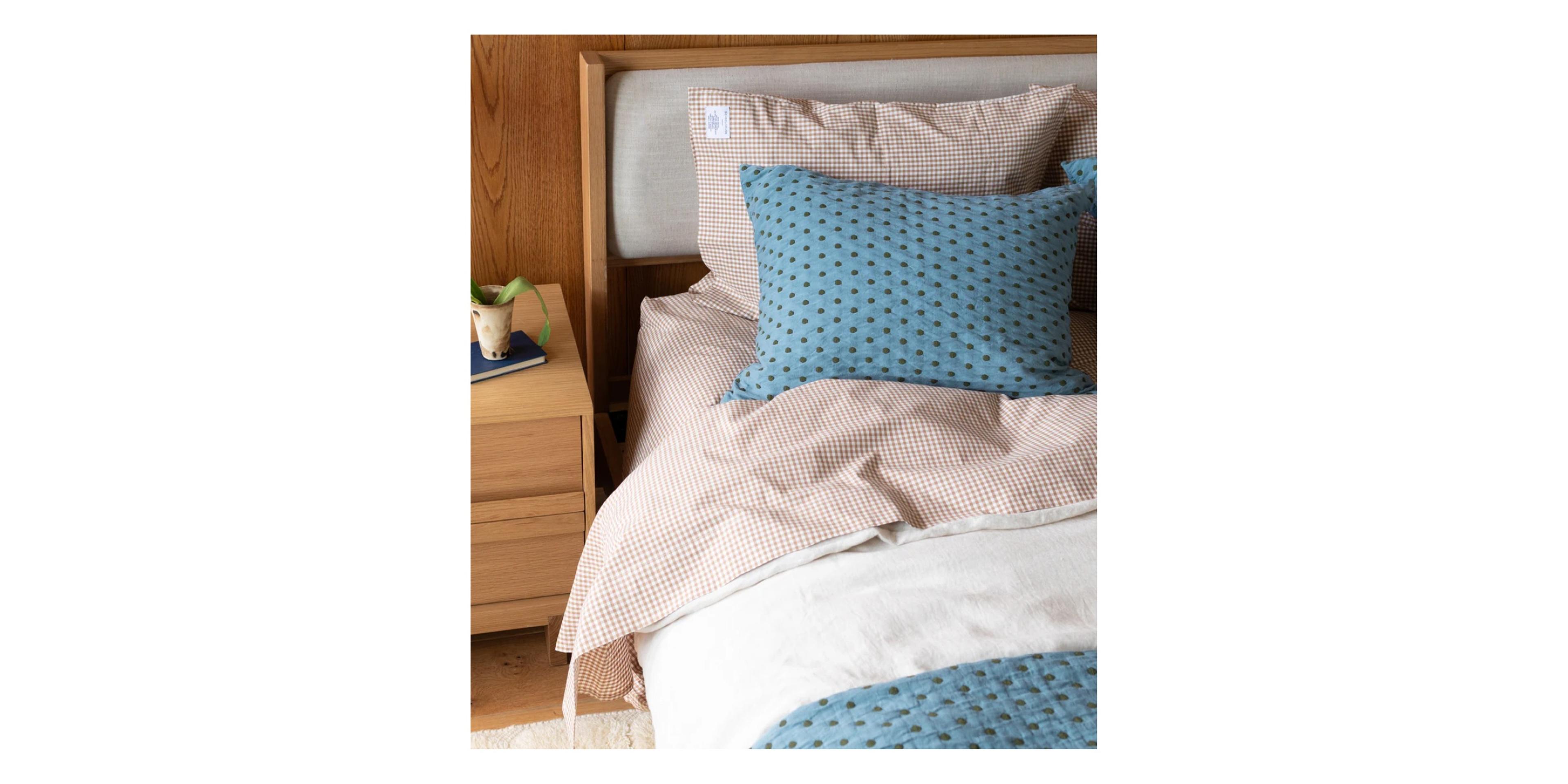 Cozy bed with blue and red bedding. 