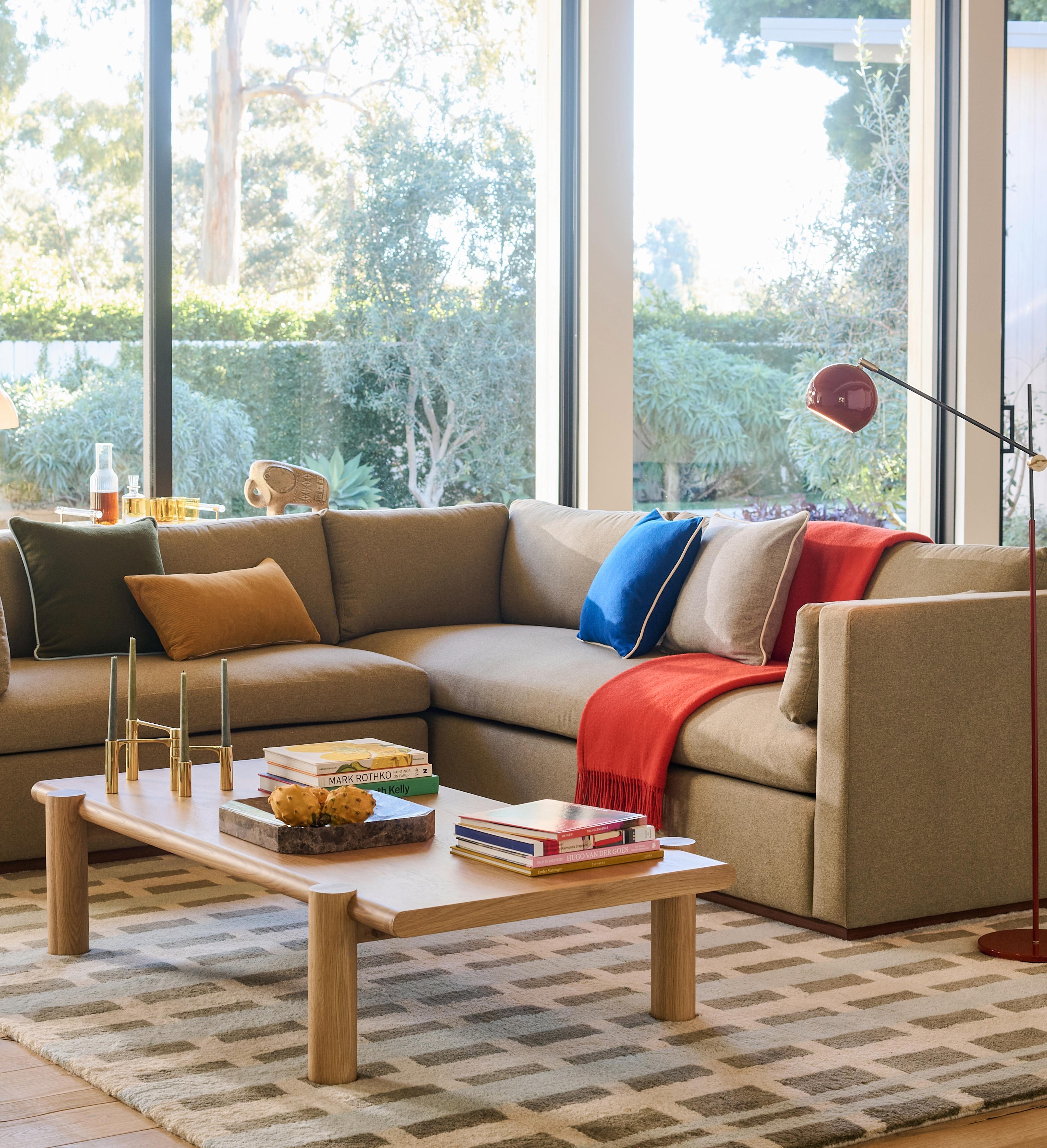 Modern living room with wooden coffee table and colorful throw pillows