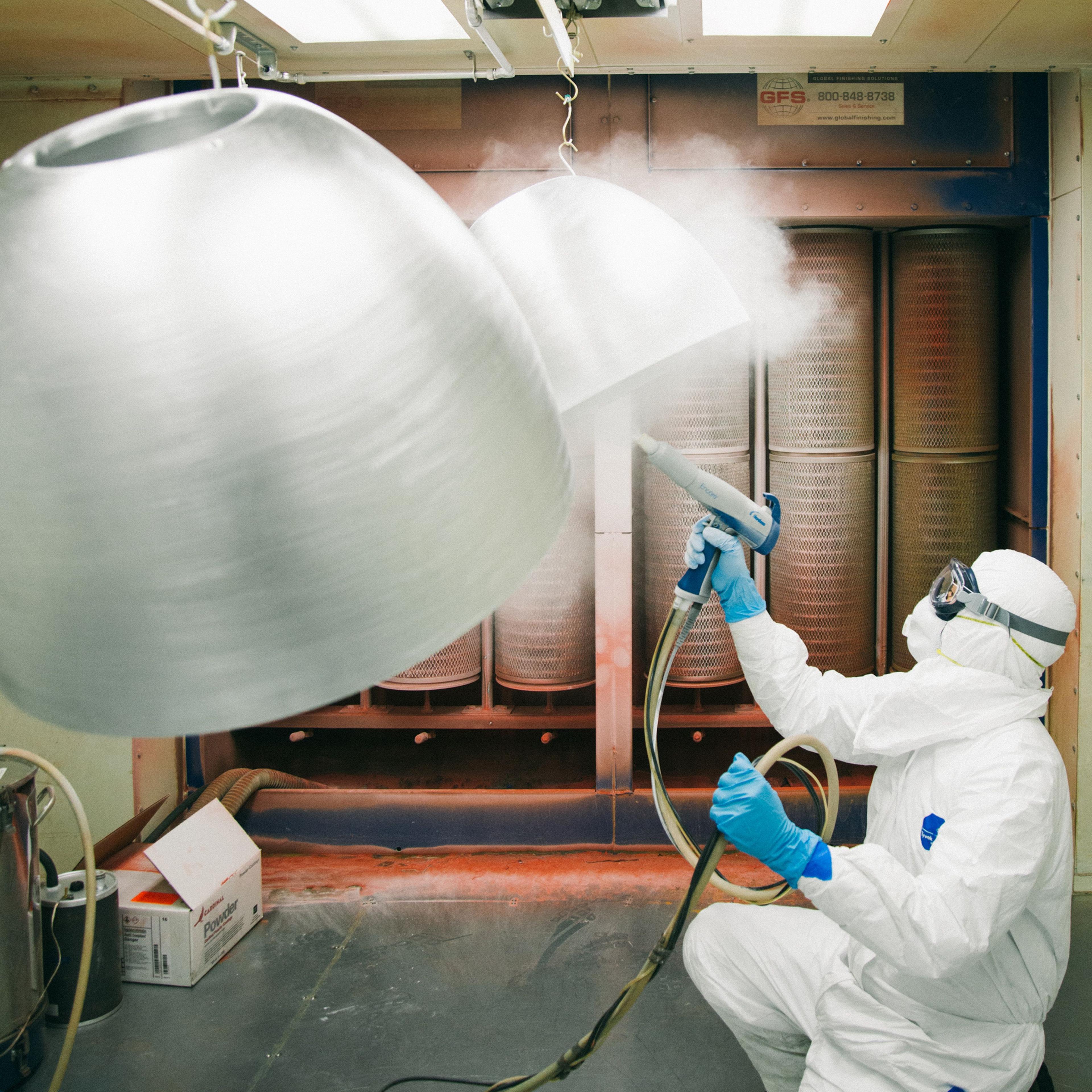 Team spraying light fixtures 