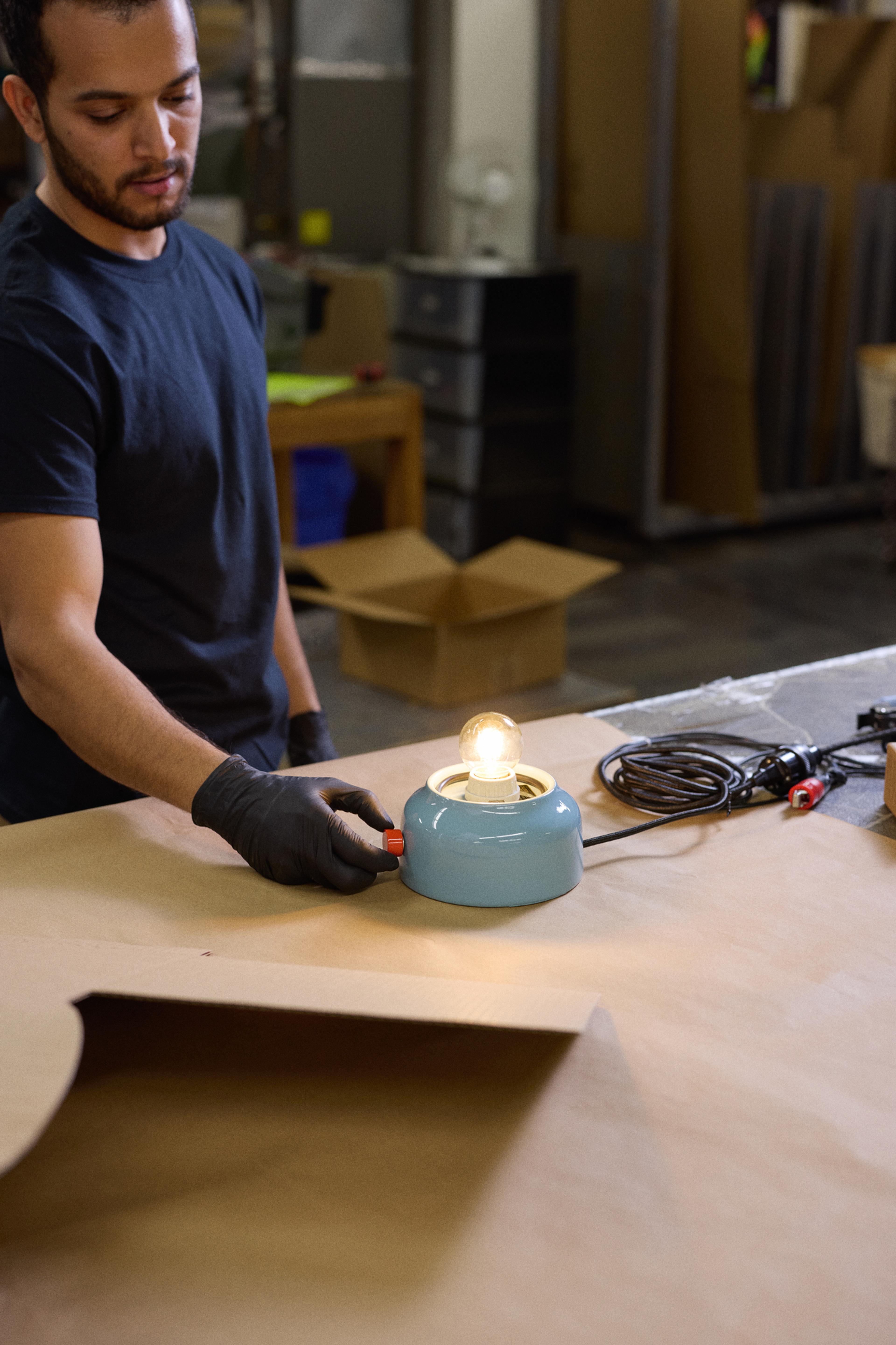 person testing light bulb