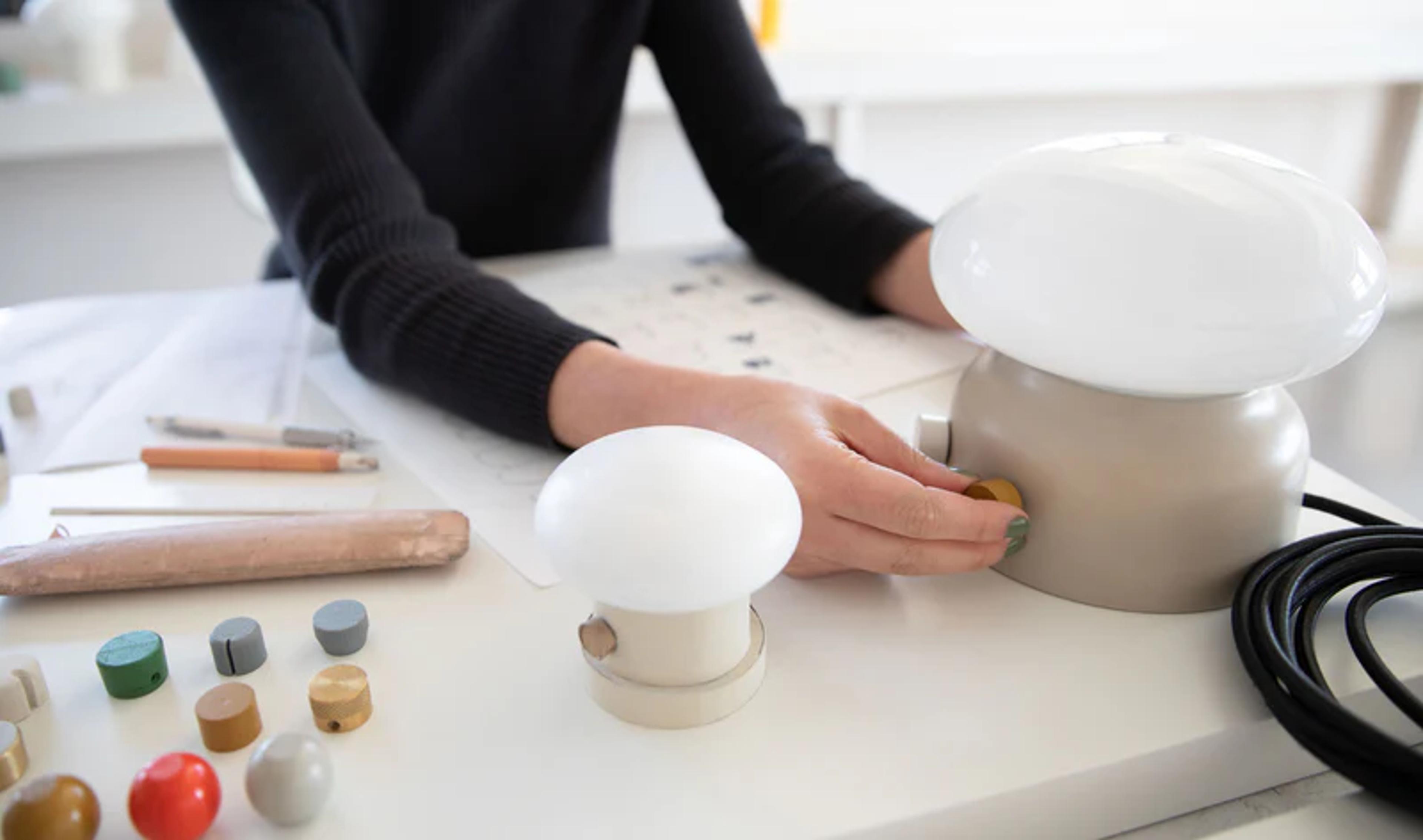 A person working on a short tan lamp.