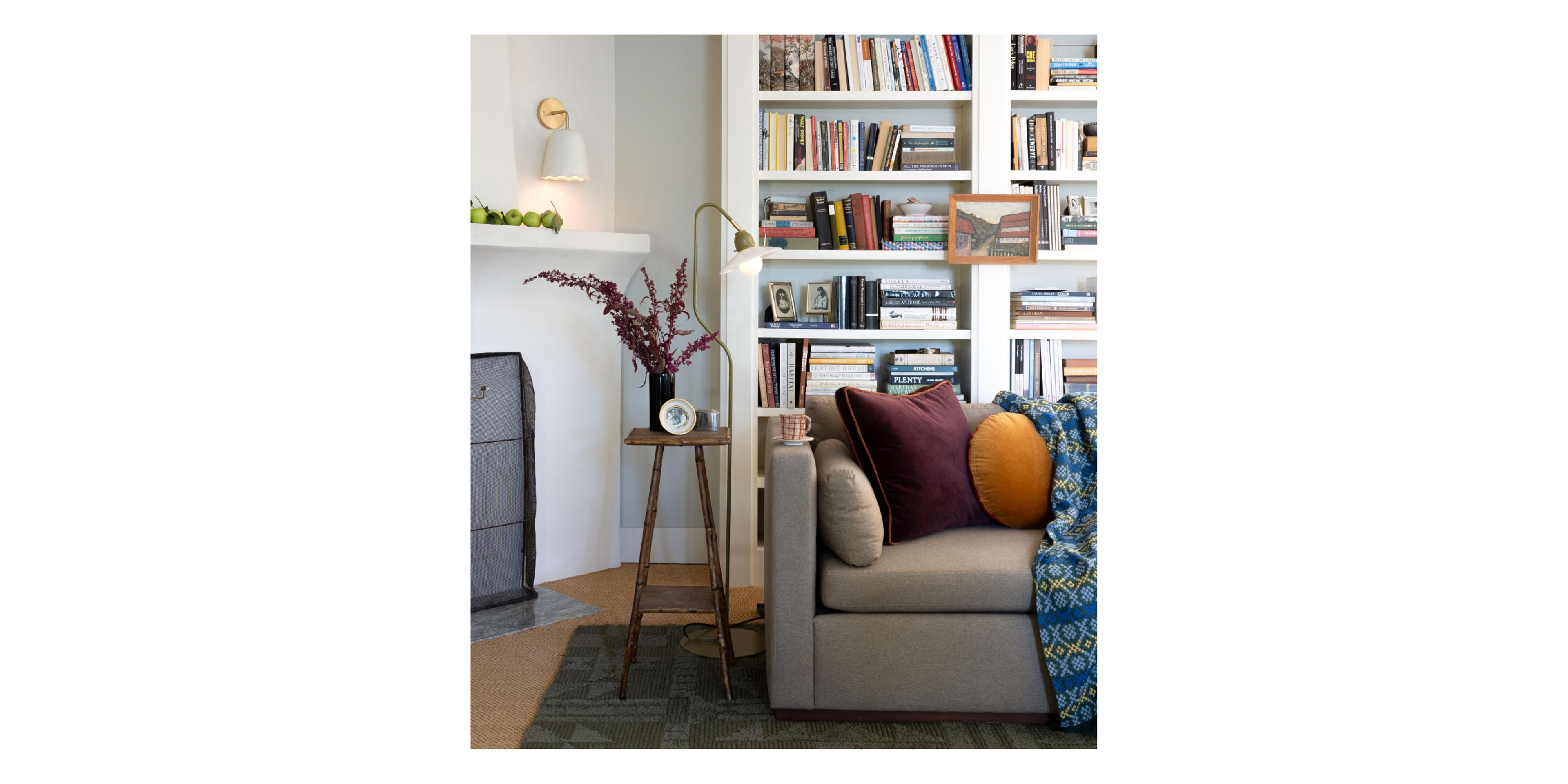 living room couch with pillows and side table with floor lamp