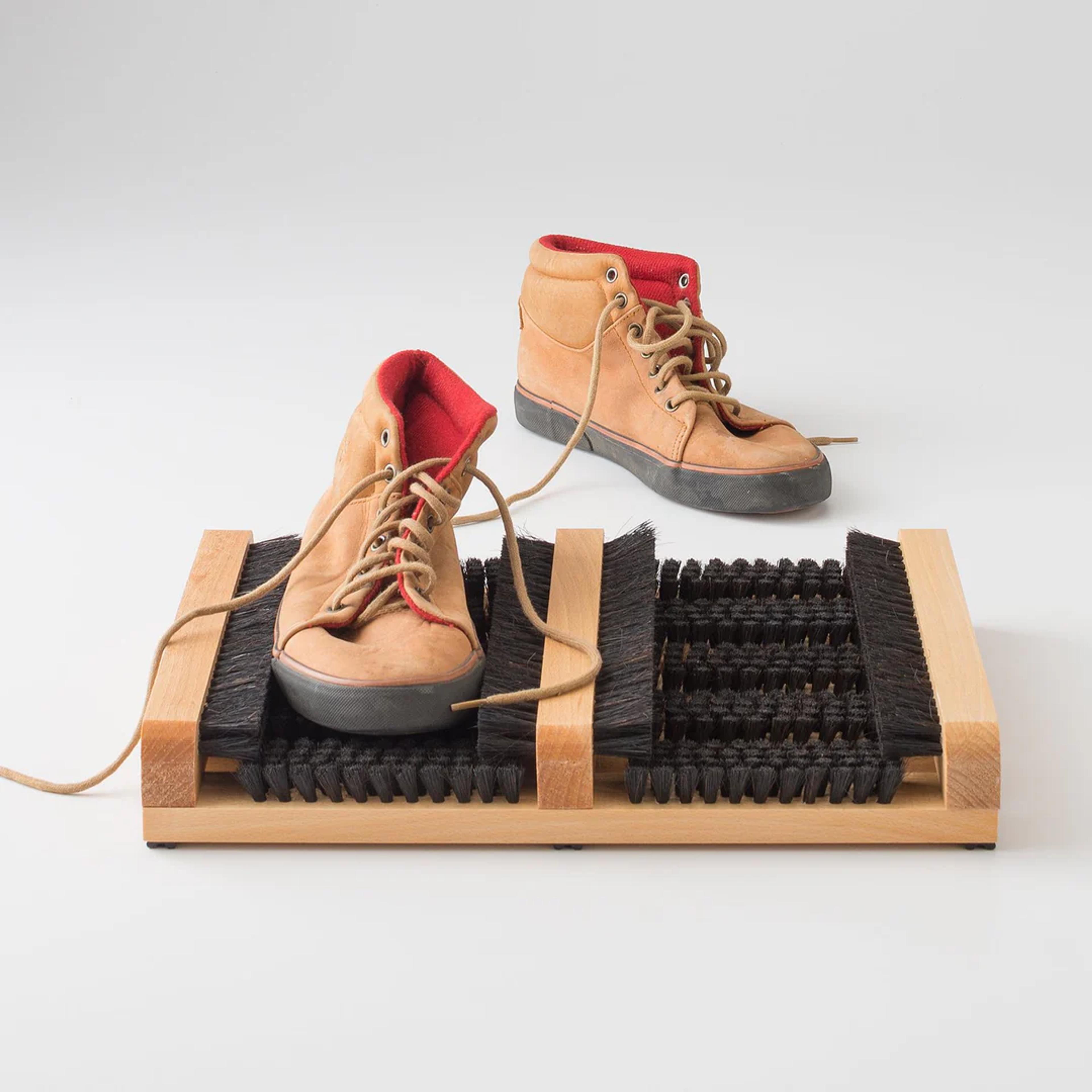 Shoes on a boot brush.