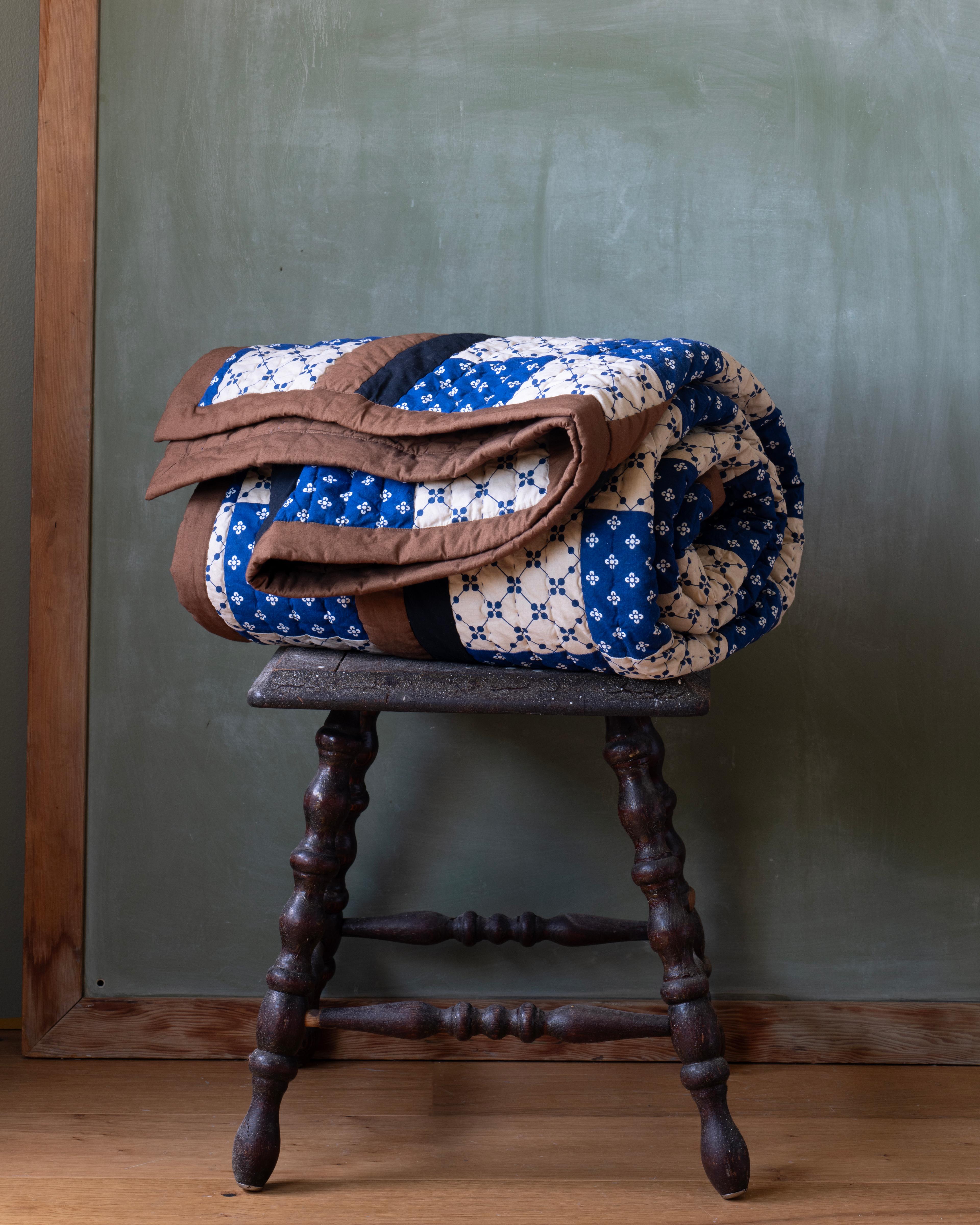 Quilt on a stool.