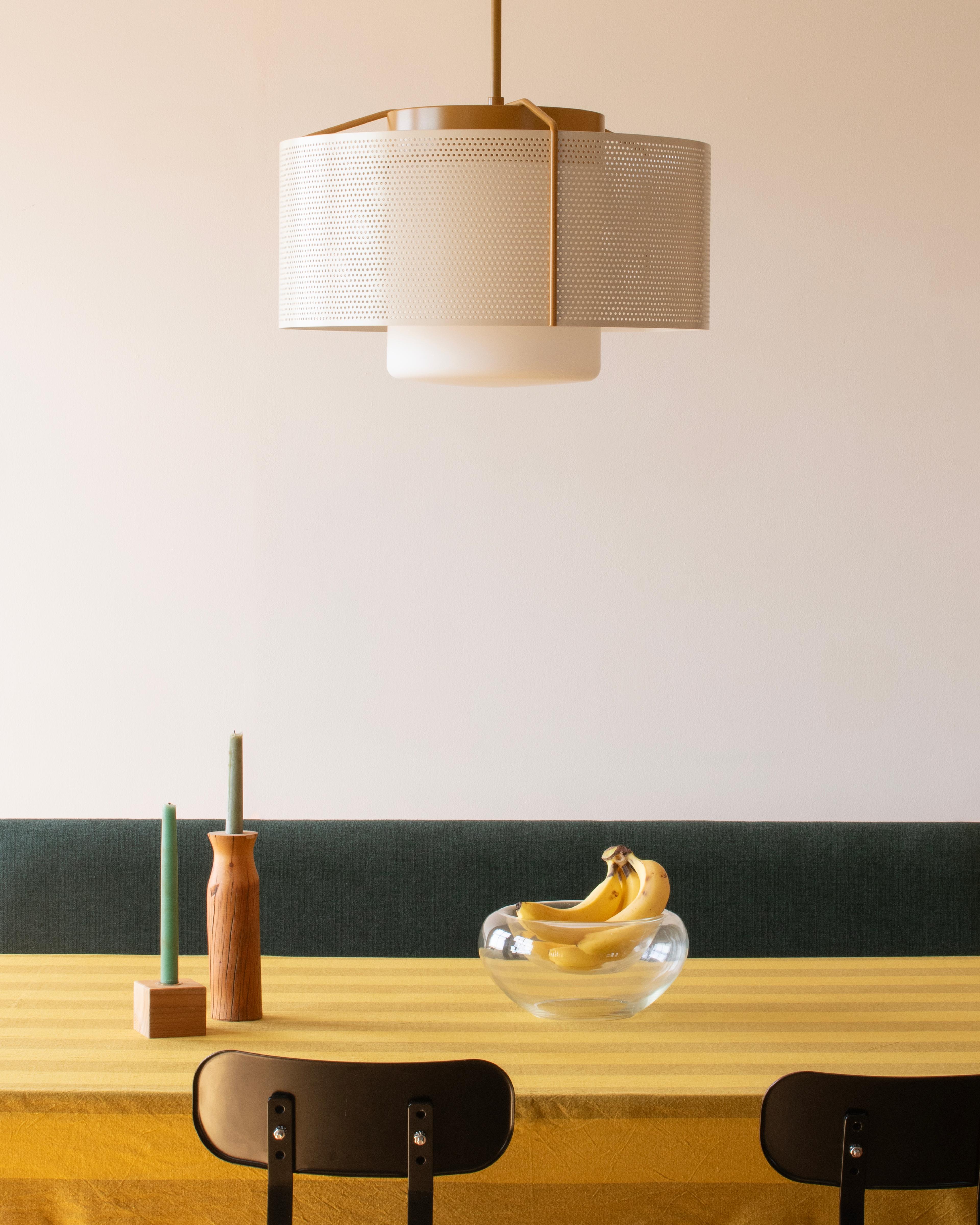 cream perforated pendant above dining table with yellow table cloth
