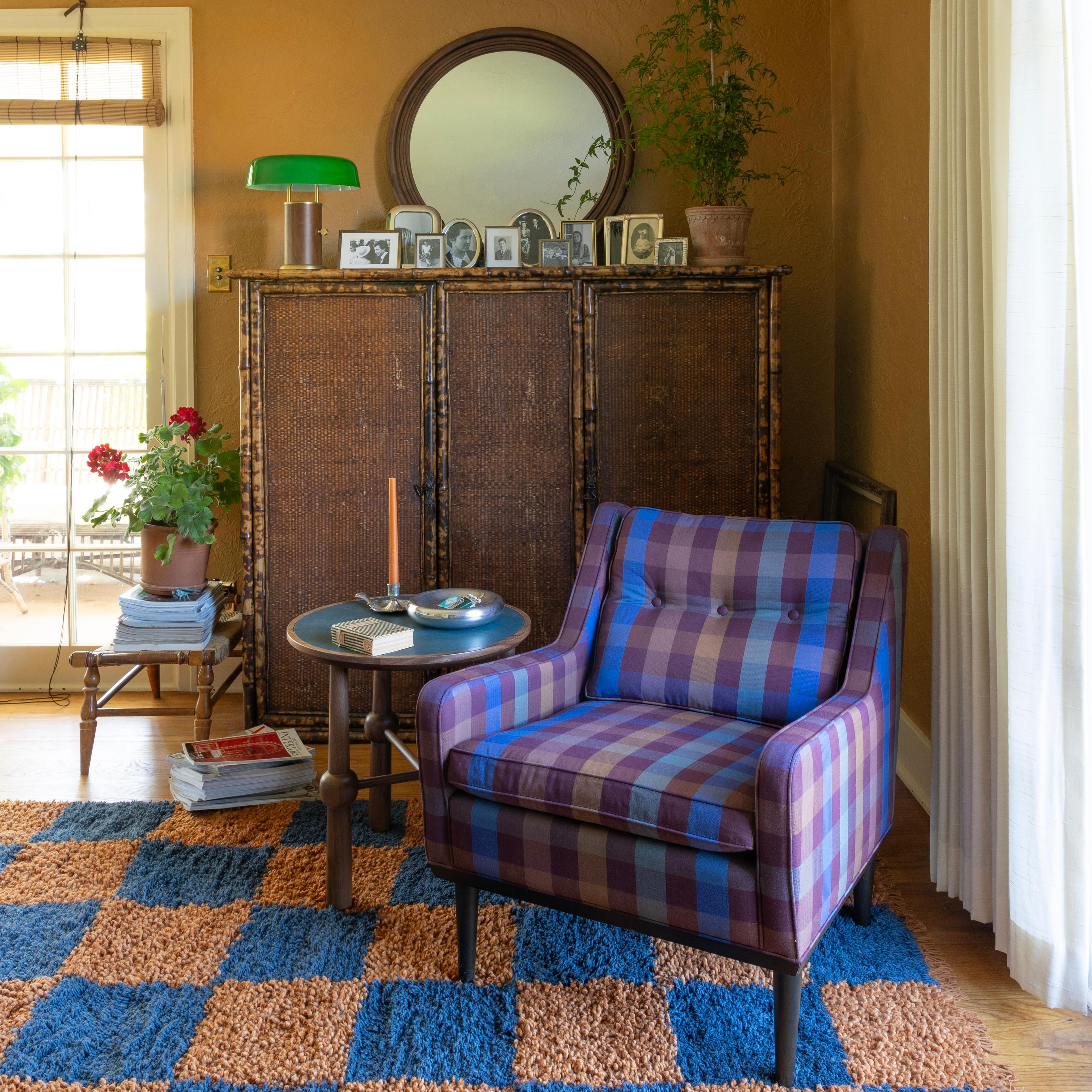 Cozy plaid armchair in living room.