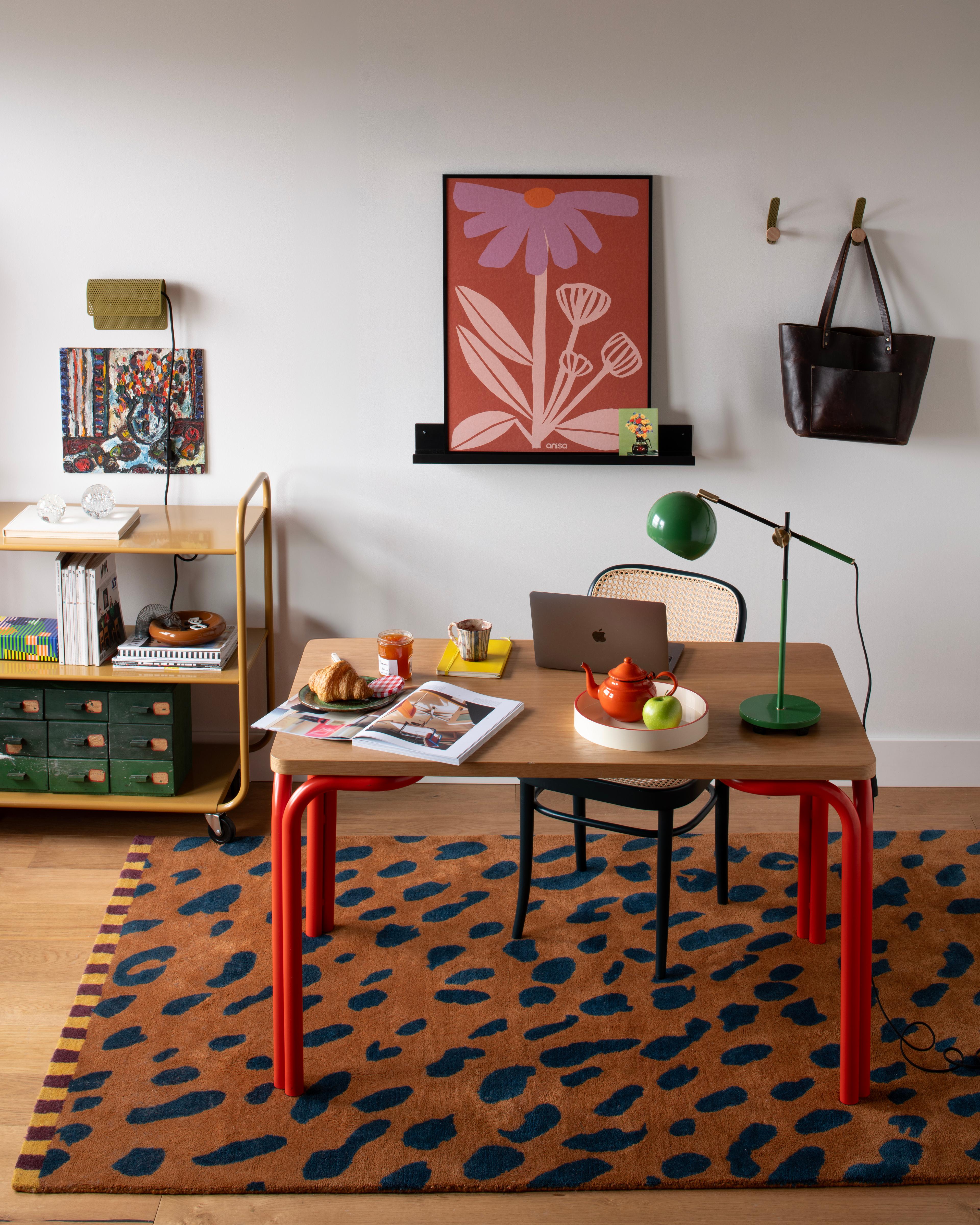 Modern office with bold patterned rug and floral print