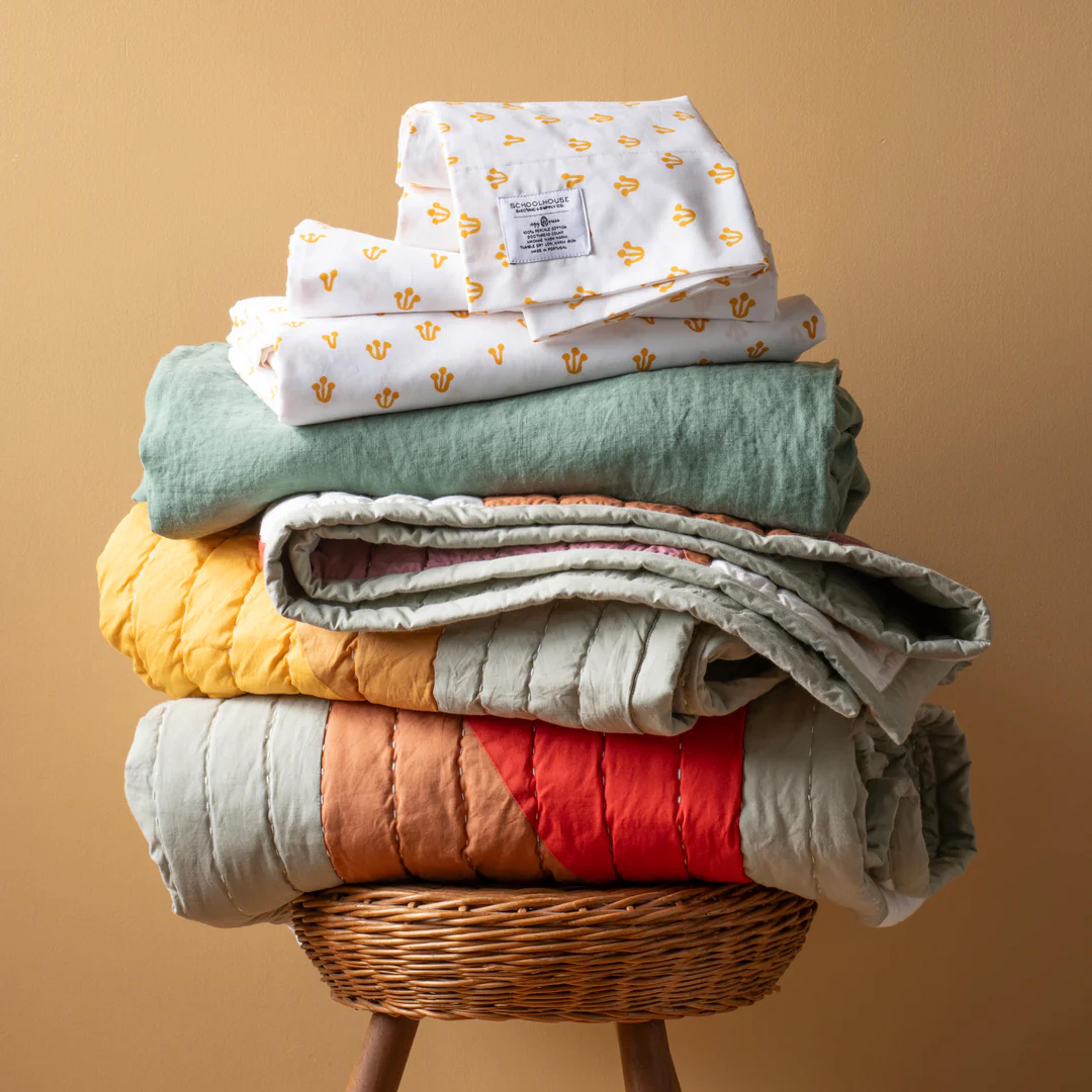 Bedding stack on a stool.