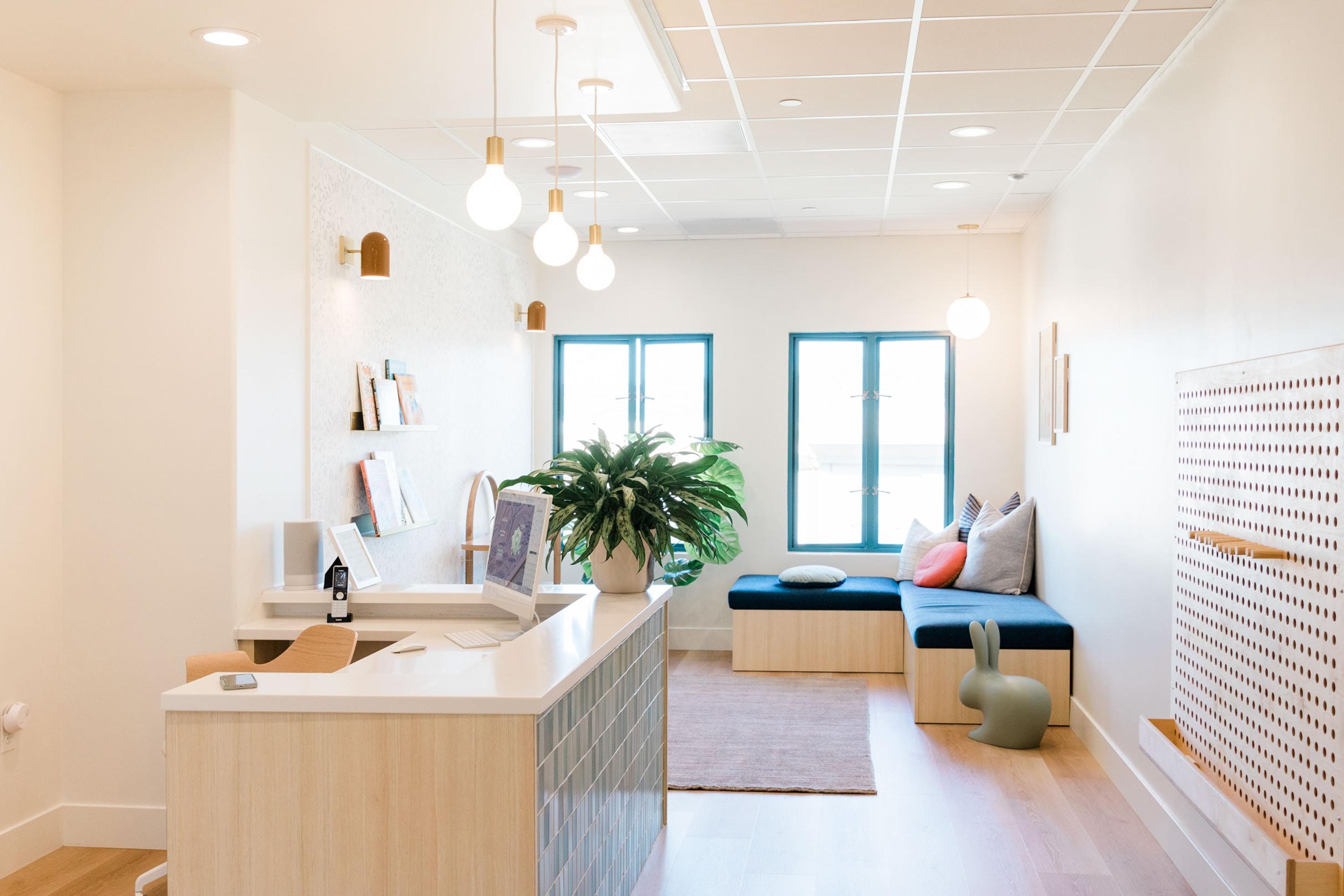 A bright pediatric dentist office with hanging exposed bulb pendants.