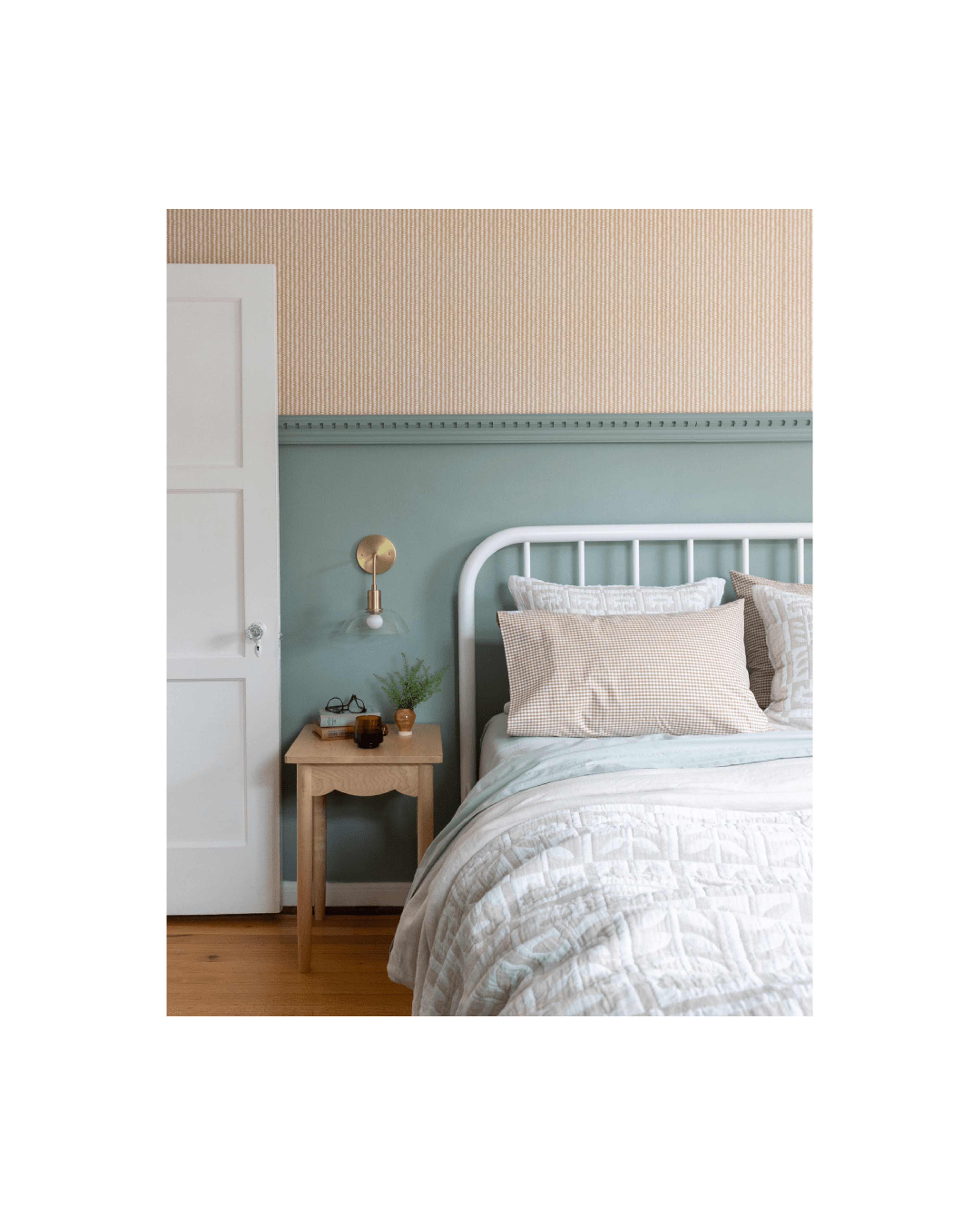 Blue bedroom with white bed and gingham bedding.