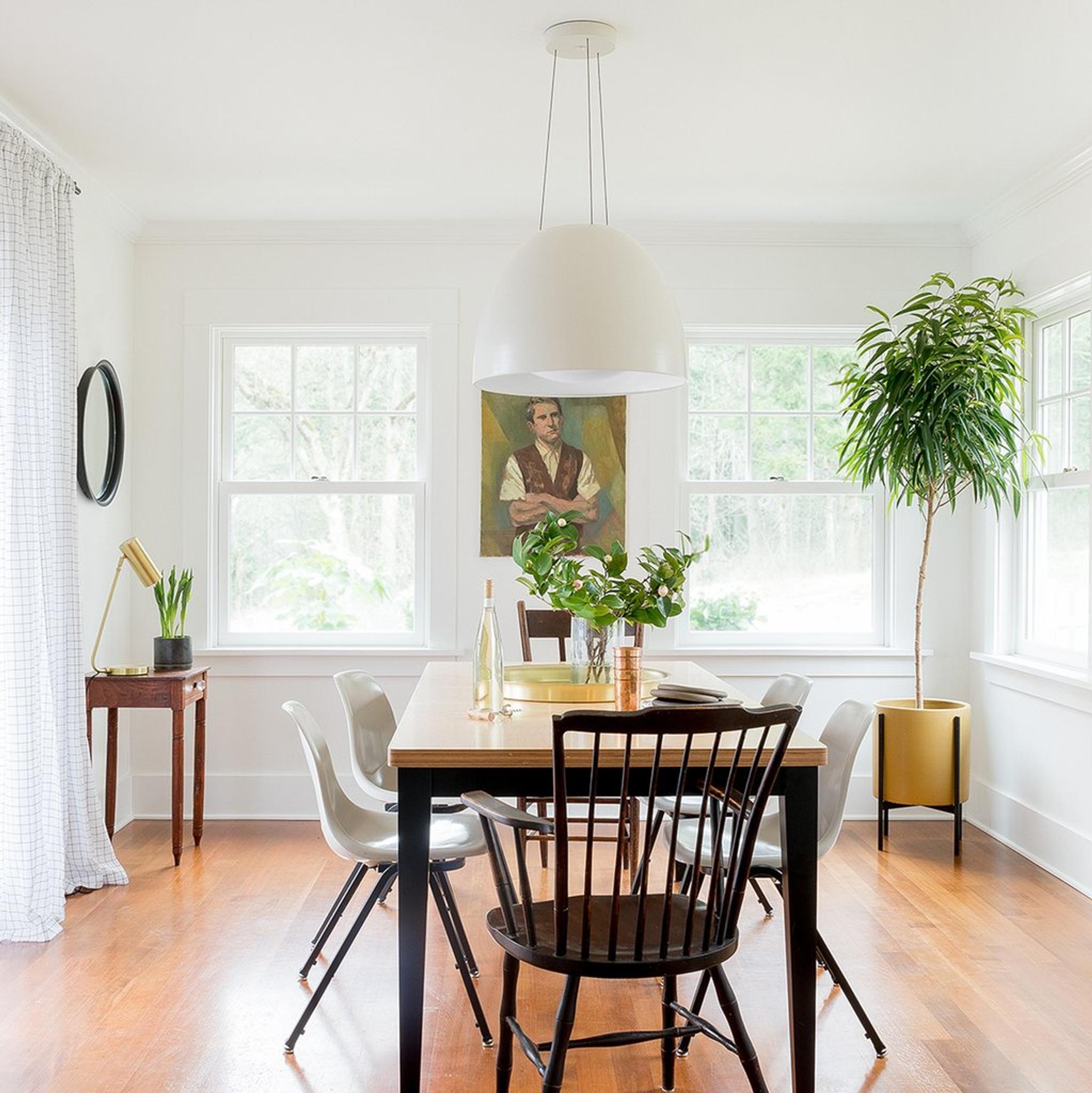 dining room with a wood floor and a plant in the corner