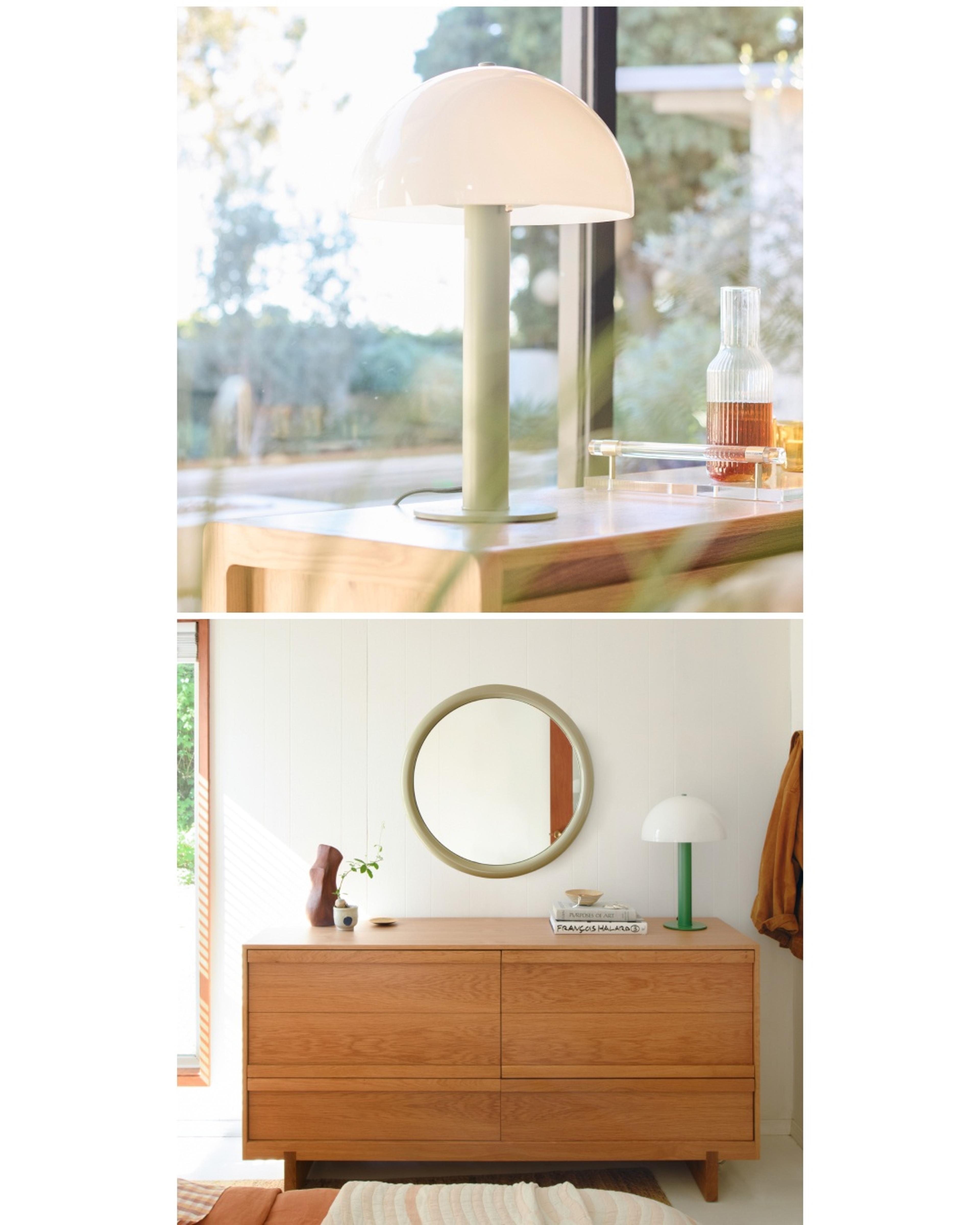 Mushroom shaped lamp on side table with sage green body and opal glass dome shade