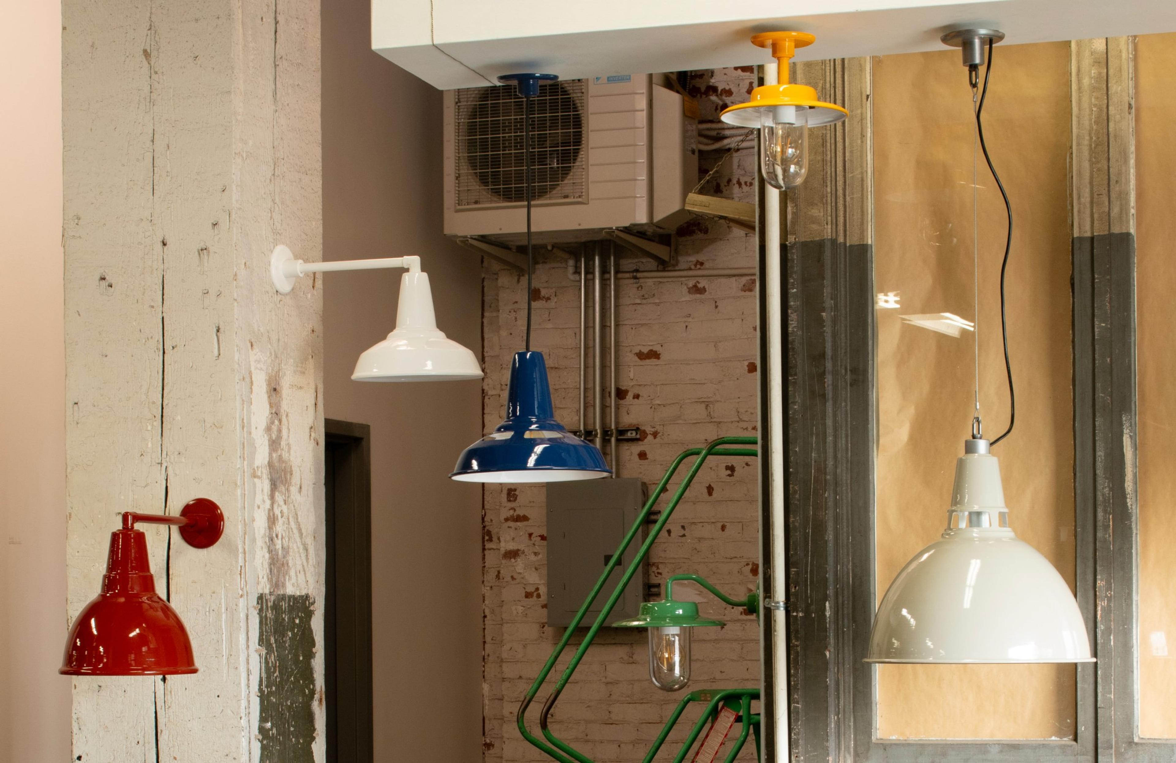 schoolhouse factory lights drying on racks are being painted
