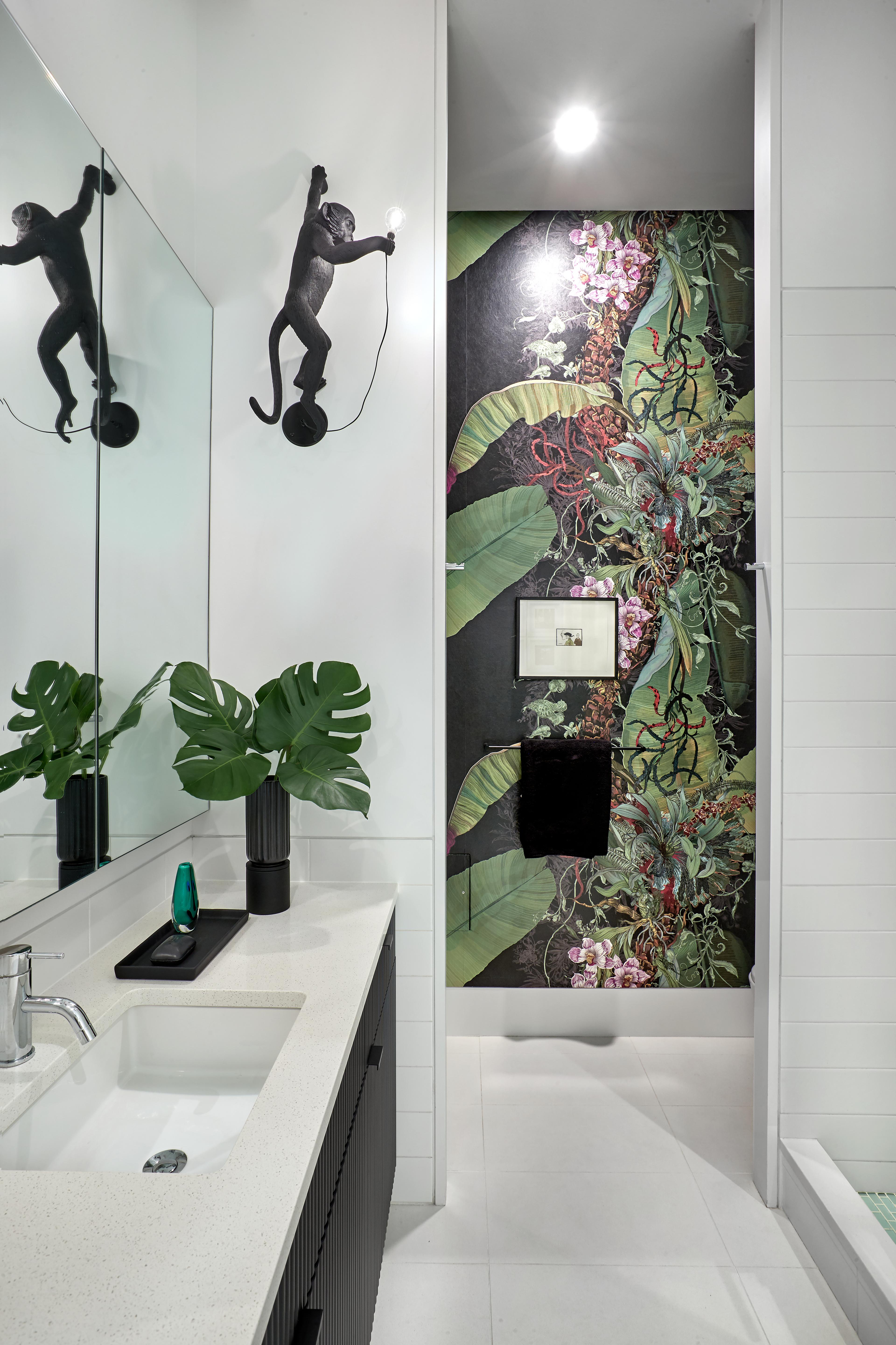 Bathroom with monkey lamp and tropical wallpaper