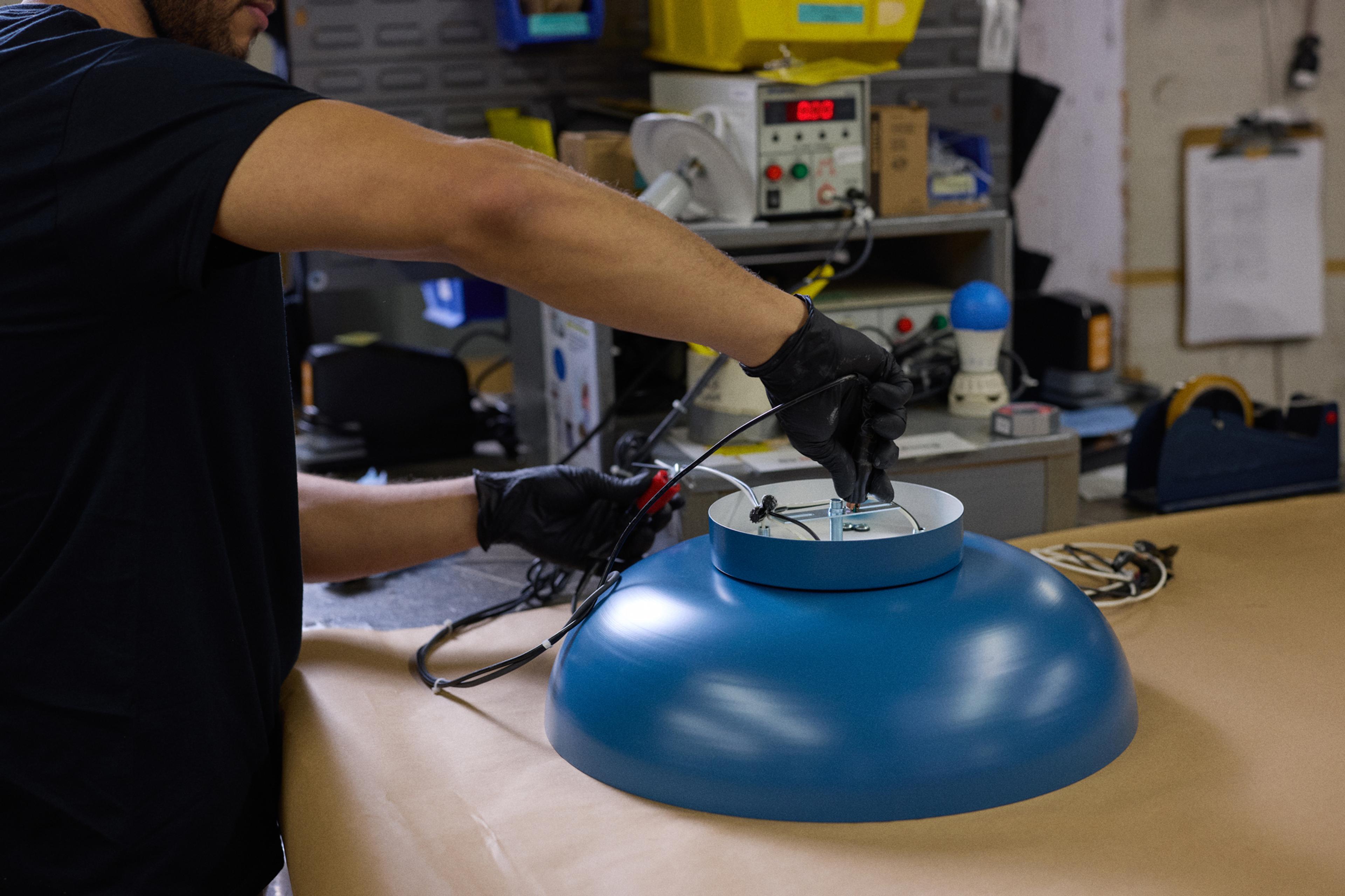 person testing a light fixture