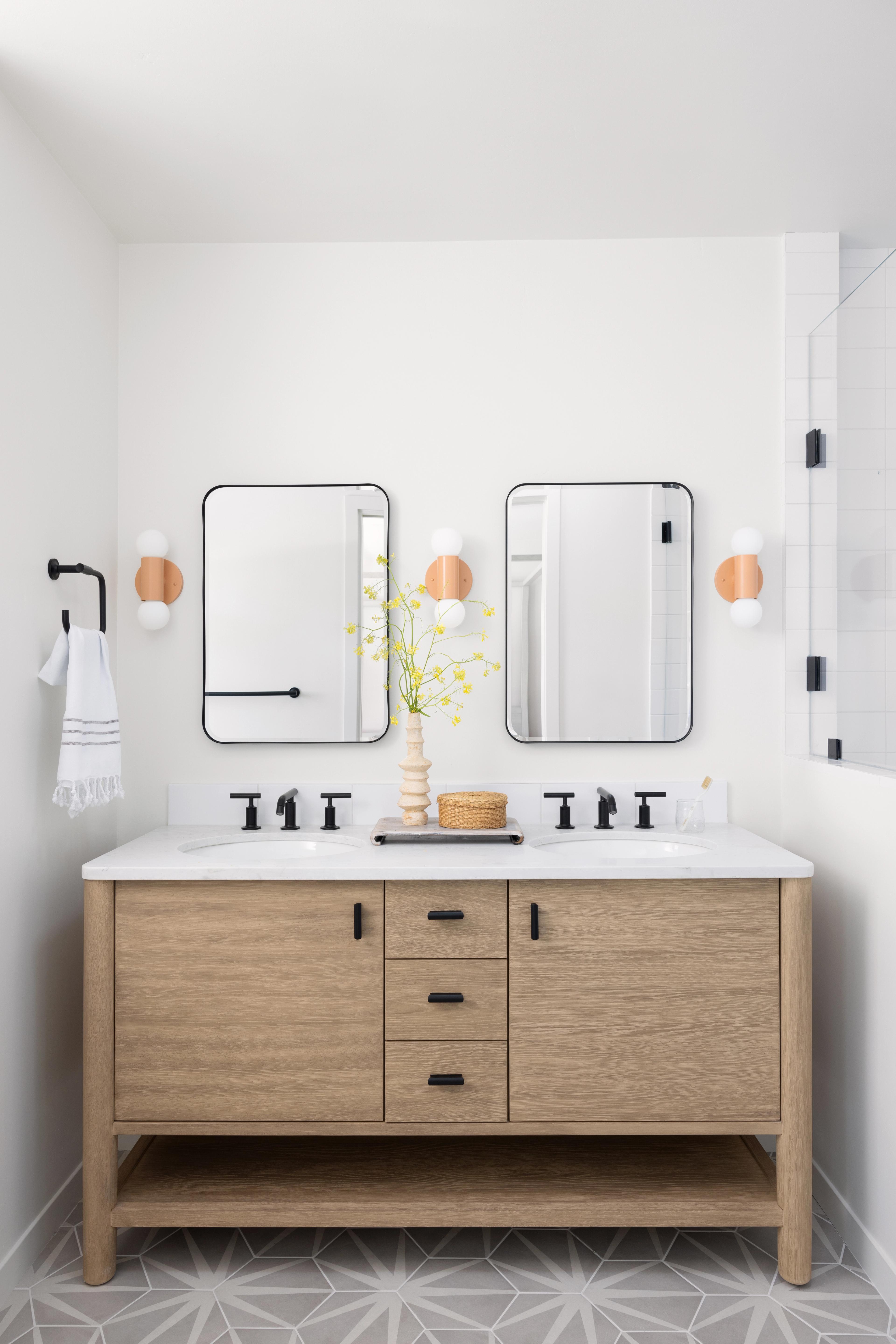 Pink sconces in modern bathroom.