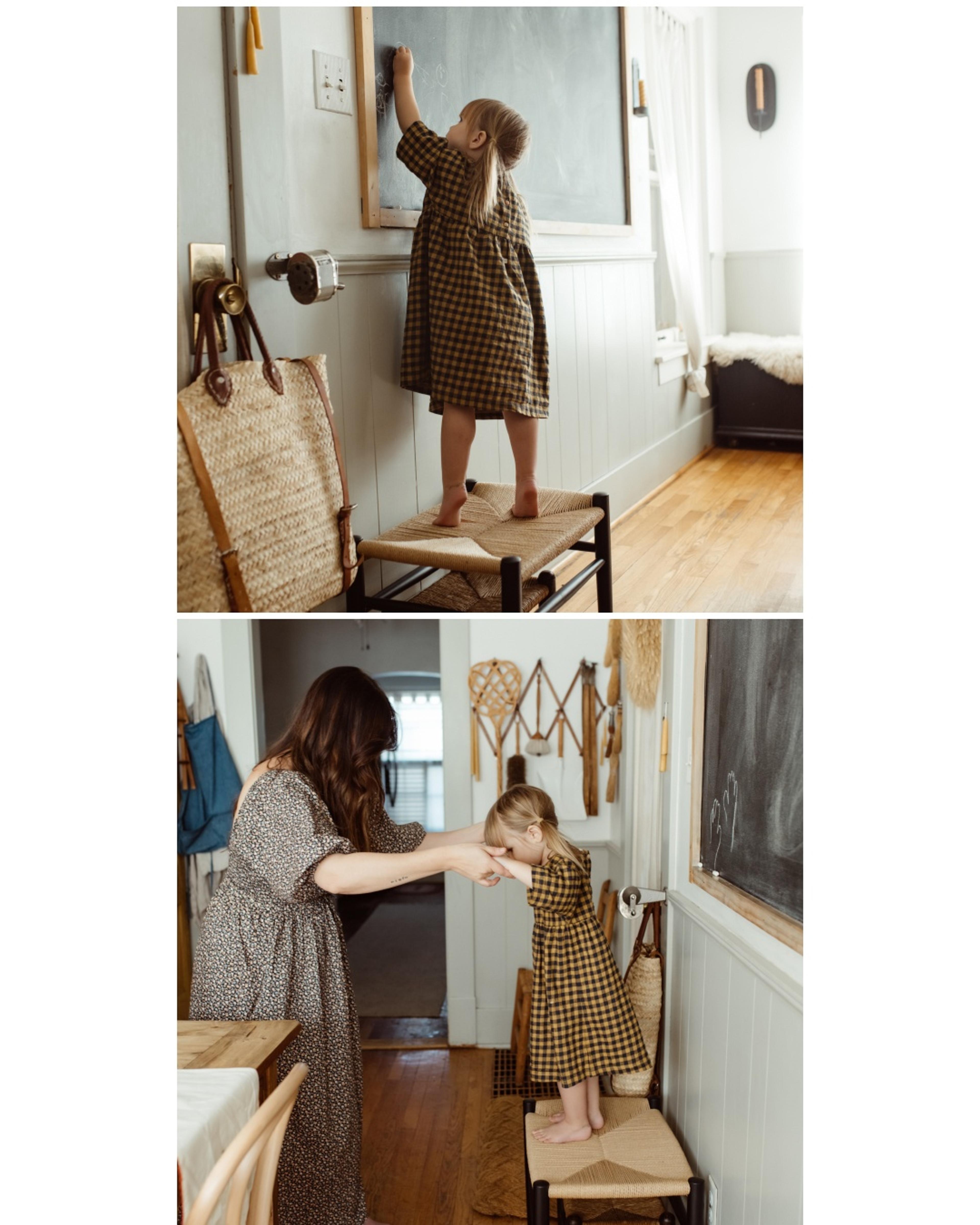 Farmhouse kitchen with wooden table, blackboard and butterscotch clock