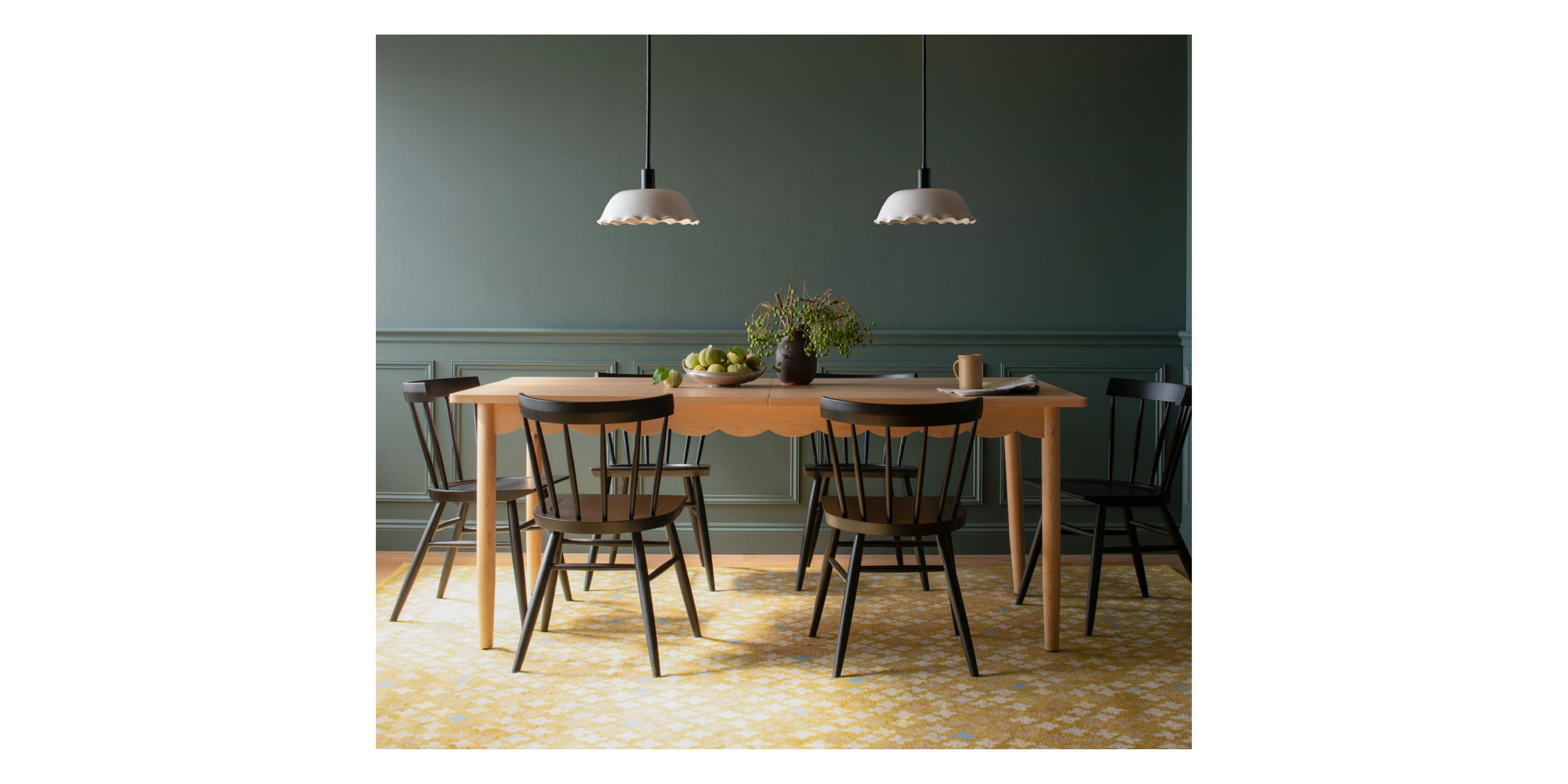 studio shot of long table with scalloped pendants above