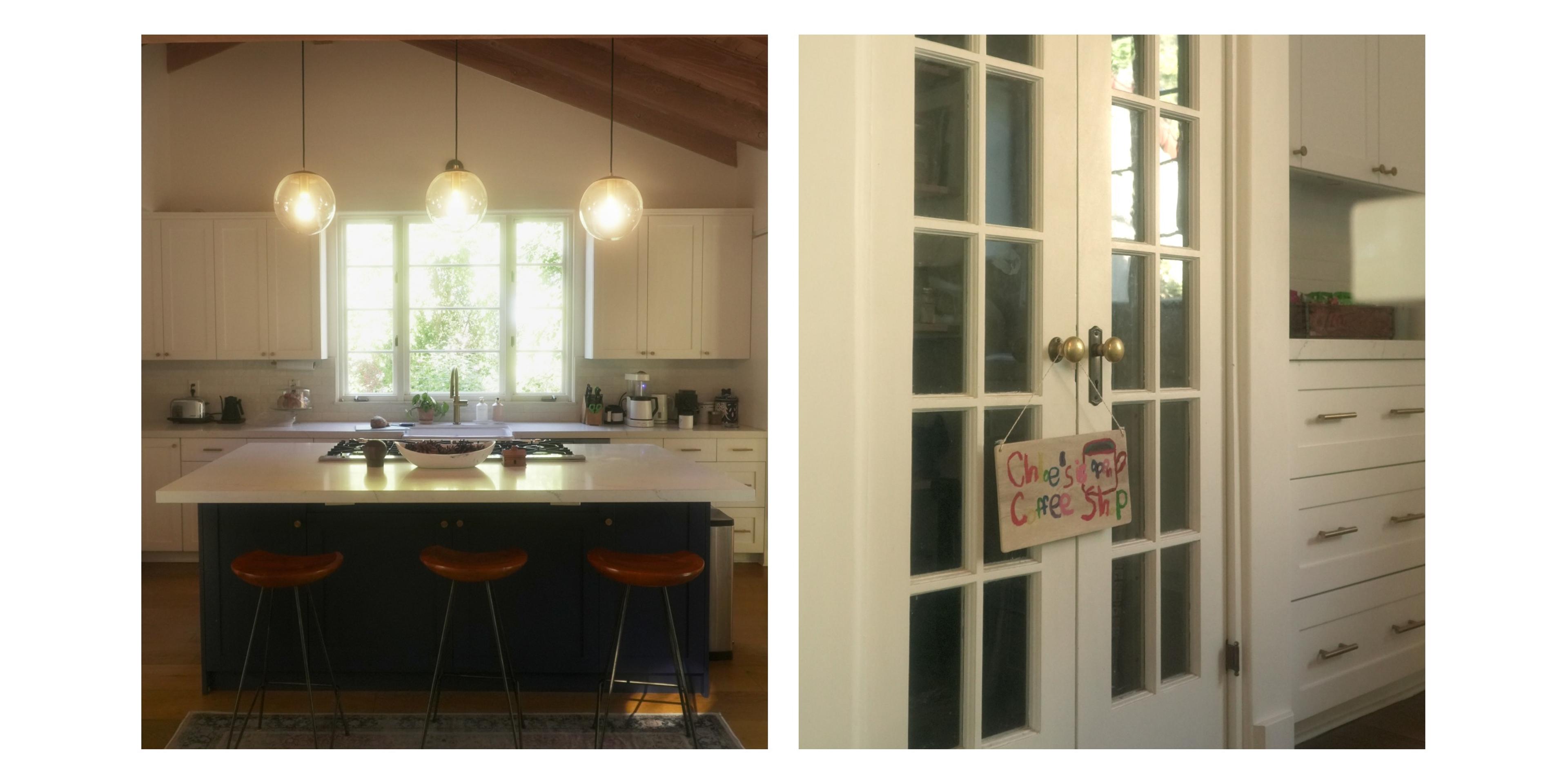 kitchen island with 3 pendants hanging over and white bay doors with sign that says "Chloe's coffee shop"