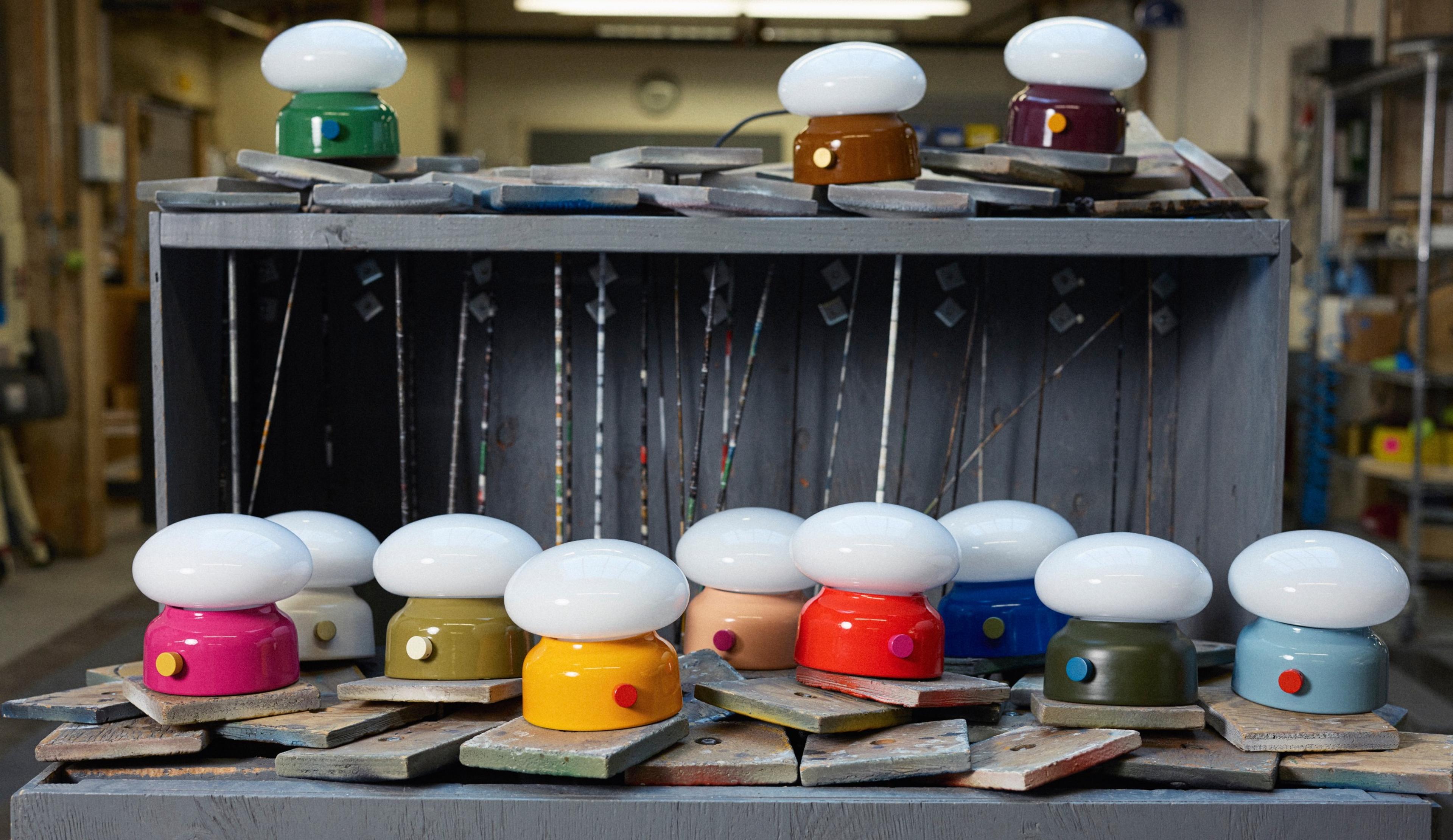 Gathering of lamps in multiple colors on a wooden platform 