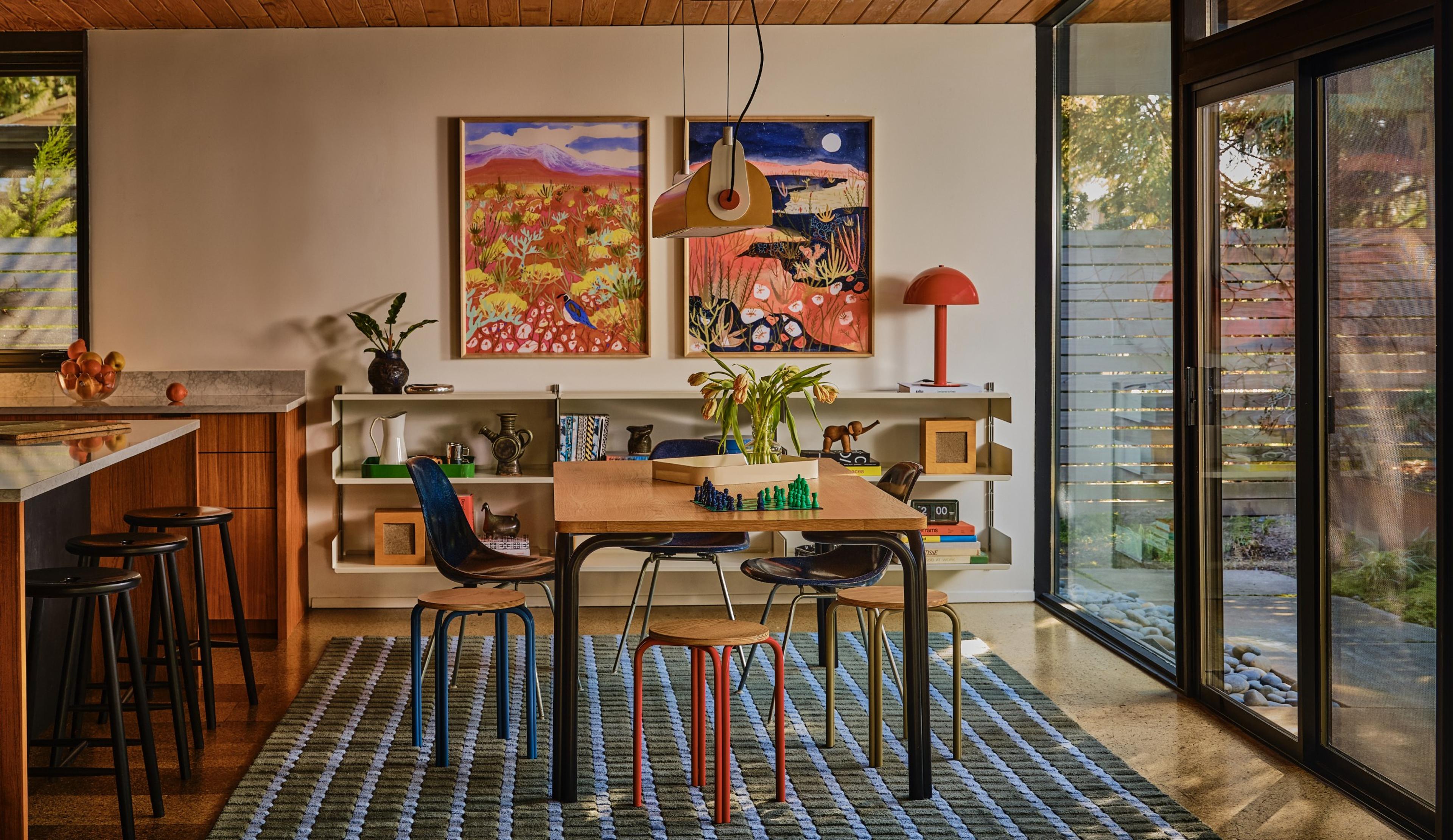 Modern dining room with chess set on the table and long chandelier hanging over head