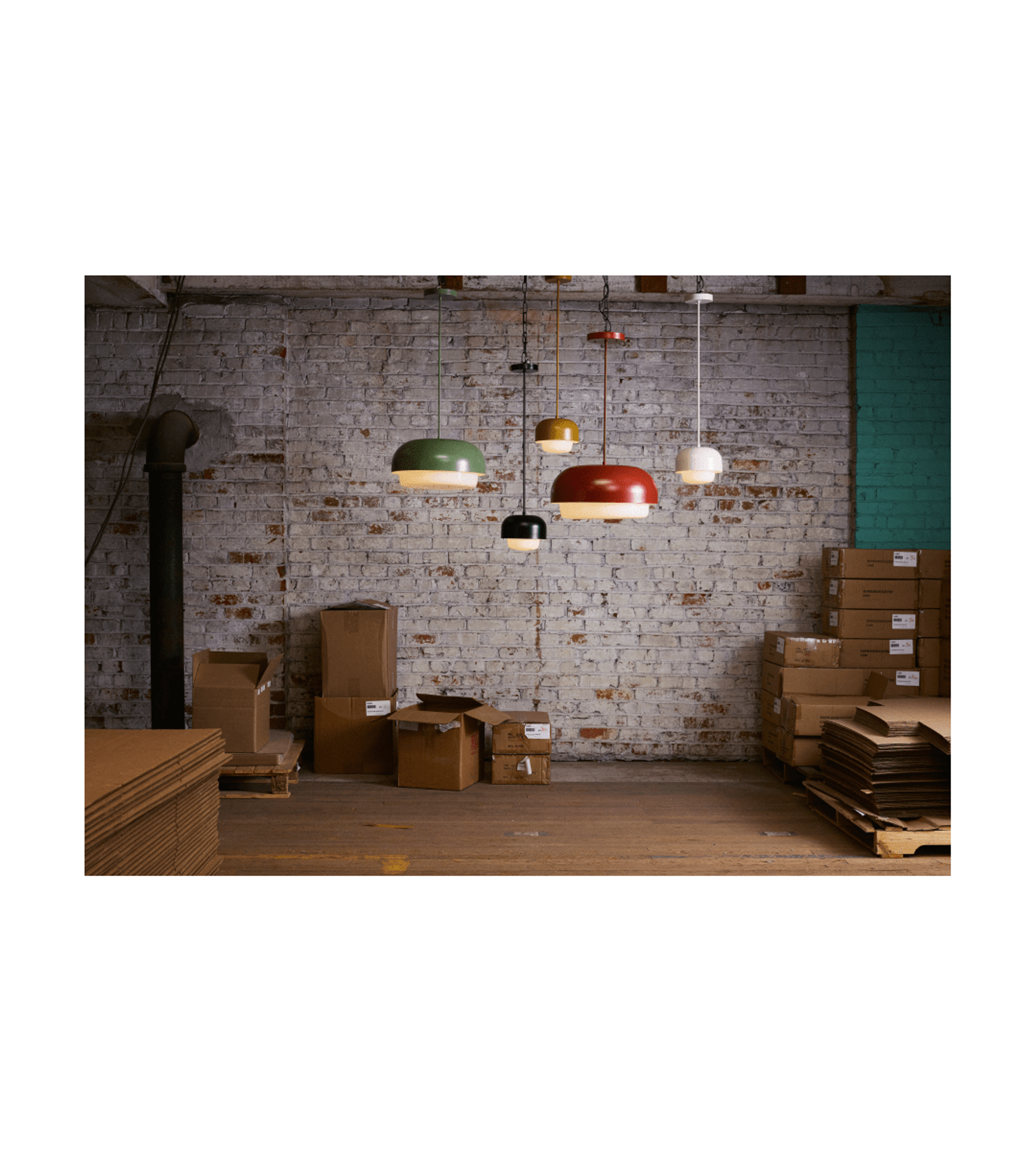 5 pendant lamps in different colors in front of brick wall